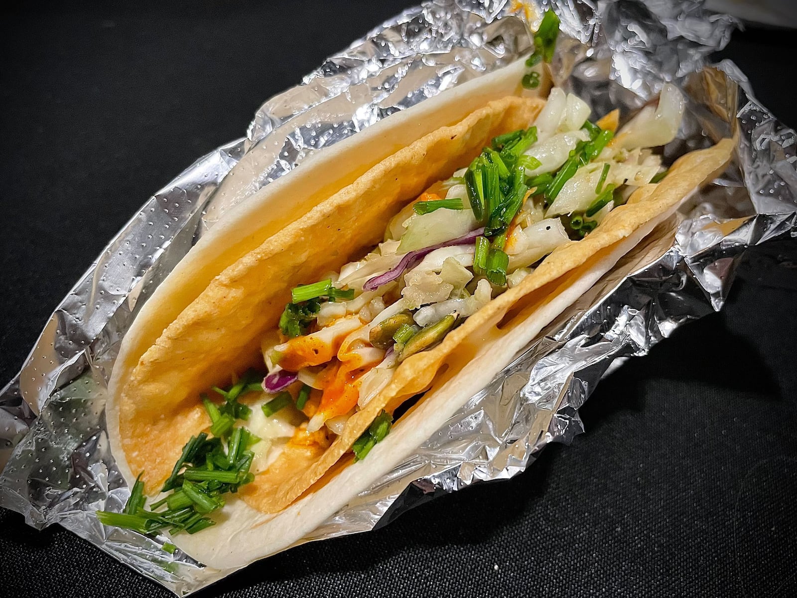 Sneak Peek to Winter Restaurant Week at the Steam Plant on Jan. 22, 2025 featured samples from 12 restaurants in the Dayton region. Pictured is a buffalo chicken taco from Condado Tacos. NATALIE JONES/STAFF