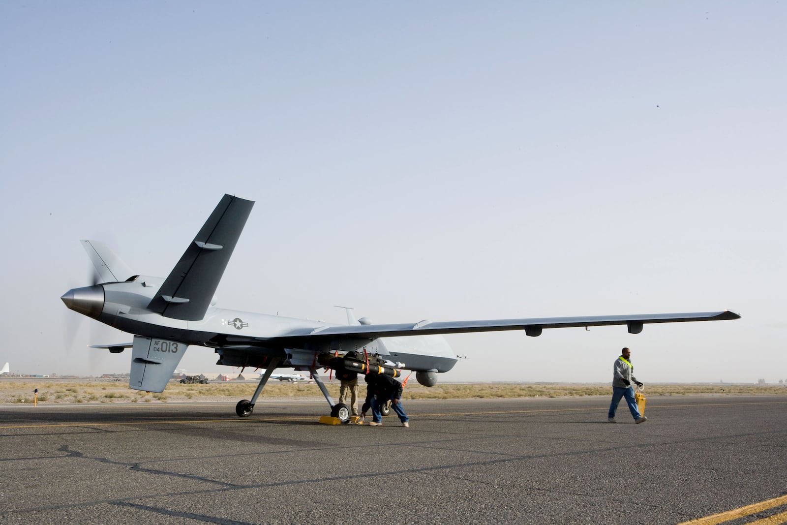 Aircrews perform a preflight check on an MQ-9 Reaper before it takes of for a mission in Afghanistan Sept. 31. The Reaper is larger and more heavily-armed than the MQ-1 Predator and in addition to its traditional ISR capabilities, is designed to attack time-sensitive targets with persistence and precision, and destroy or disable those targets. (Courtesy photo)