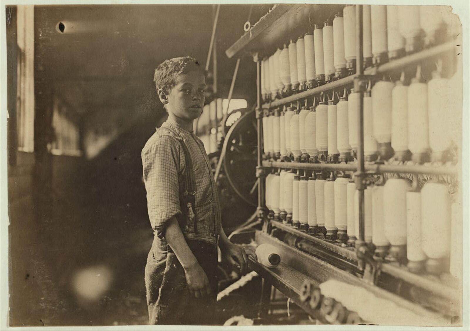 John Dempsey, said to be 12 years old, working in the mule-spinning room at Jackson Mill, Fiskeville, R.I. in 1909 - Photo by Lewis Wickes Hine for the National Child Labor Committee Library of Congress Prints and Photographs Division Washington, D.C.  (CONTRIBUTED)