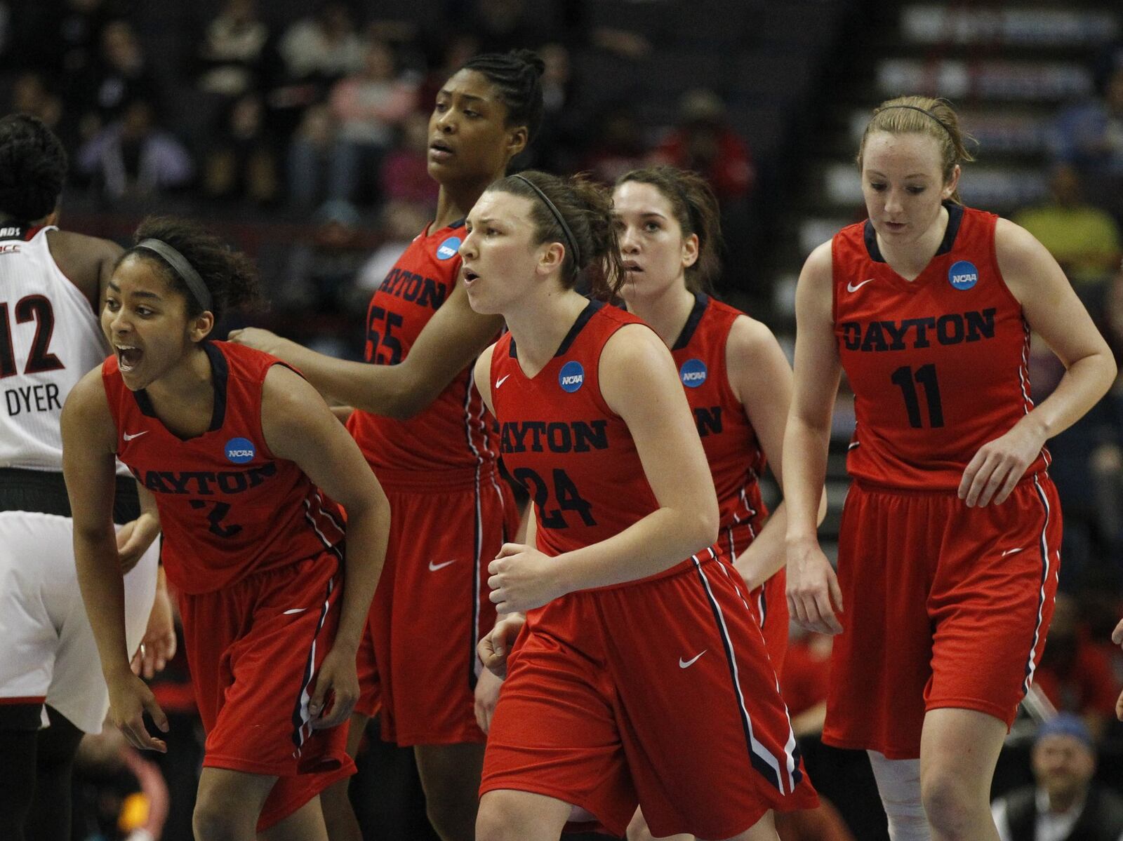 Dayton’s Andrea Hoover, center, and her teammates celebrate during a second-half run against Louisville in the third round of the NCAA tournament on Saturday, March 28, 2015, at the Times Union Center in Albany, N.Y. David Jablonski/Staff