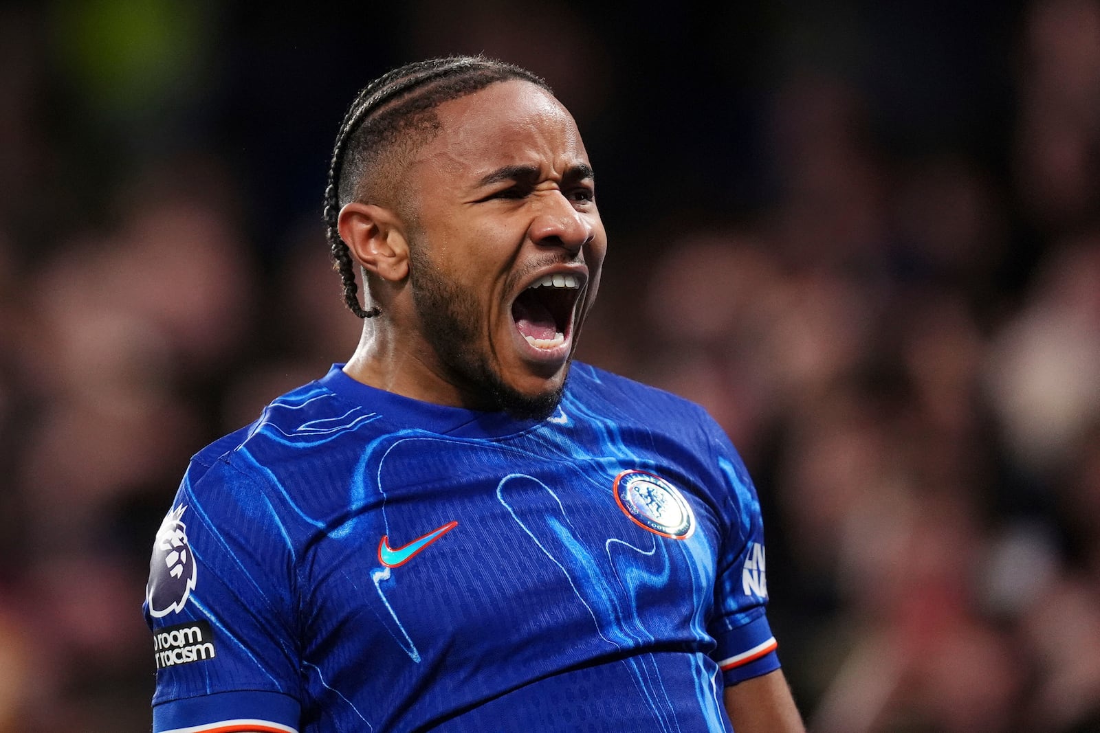 Chelsea's Christopher Nkunku celebrates scoring their side's first goal of the game during the English Premier League soccer match between Chelsea and Southampton at Stamford Bridge, London, Tuesday, Feb. 25, 2025. (John Walton/PA via AP)