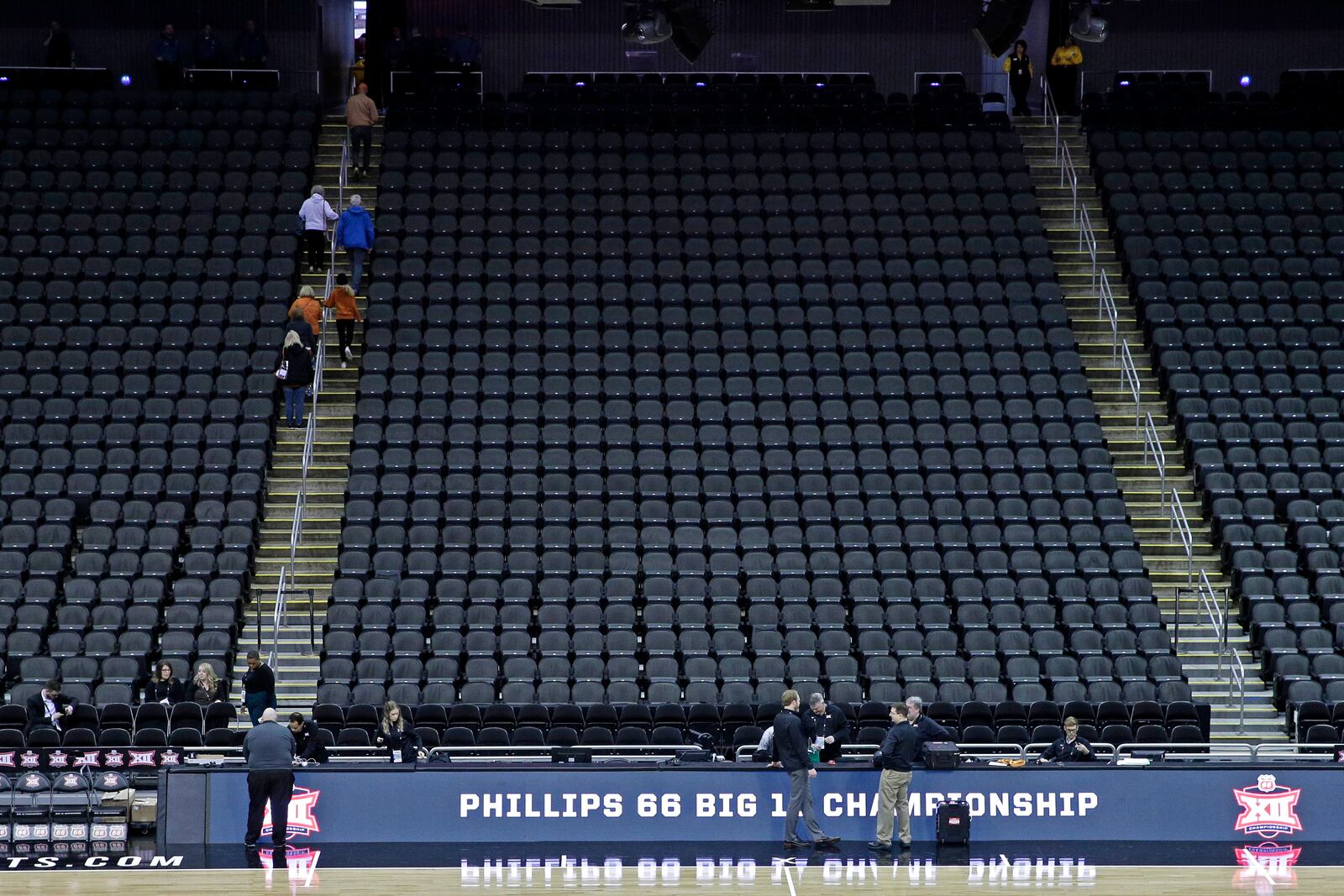 FILE - Fans leave the Sprint Center after the remaining NCAA college basketball games at the Big 12 Conference tournament were canceled due to concerns about the coronavirus, Thursday, March 12, 2020, in Kansas City, Mo. (AP Photo/Charlie Riedel, File)