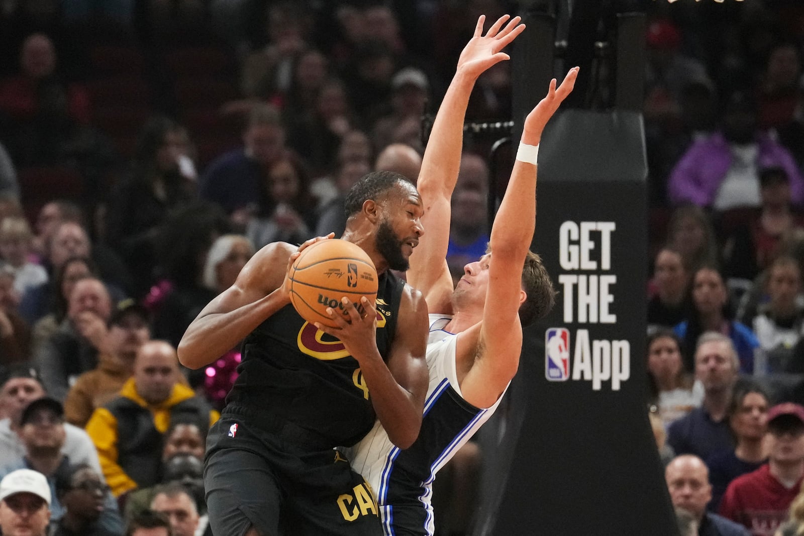 Cleveland Cavaliers forward Evan Mobley drives against Orlando Magic forward Franz Wagner, right, in the first half of an NBA game, Friday, Nov. 1, 2024, in Cleveland. (AP PhotoSue Ogrocki)