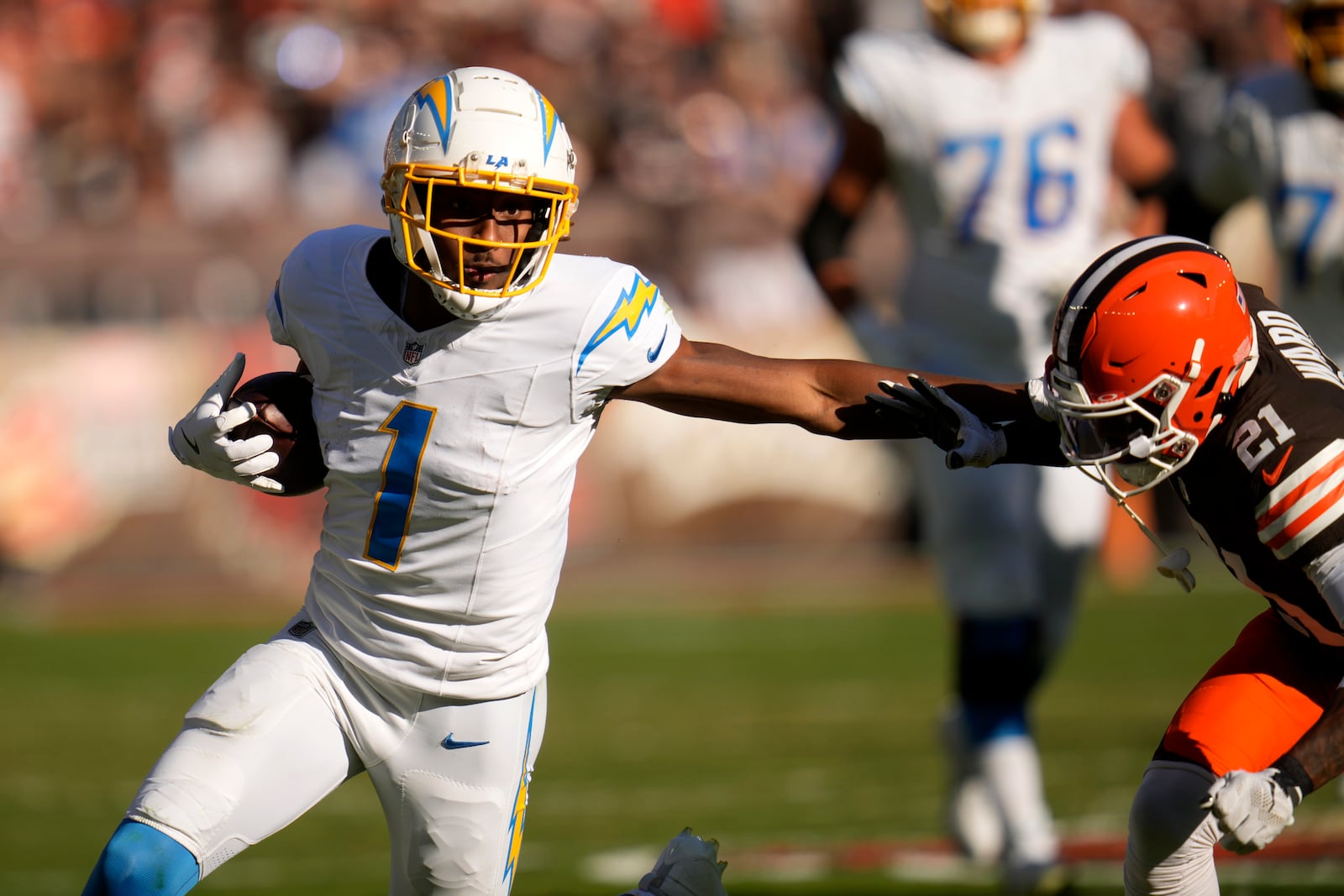 Los Angeles Chargers wide receiver Quentin Johnston (1) runs against Cleveland Browns cornerback Denzel Ward (21) in the first half of an NFL football game Sunday, Nov. 3, 2024, in Cleveland. (AP Photo/Sue Ogrocki)