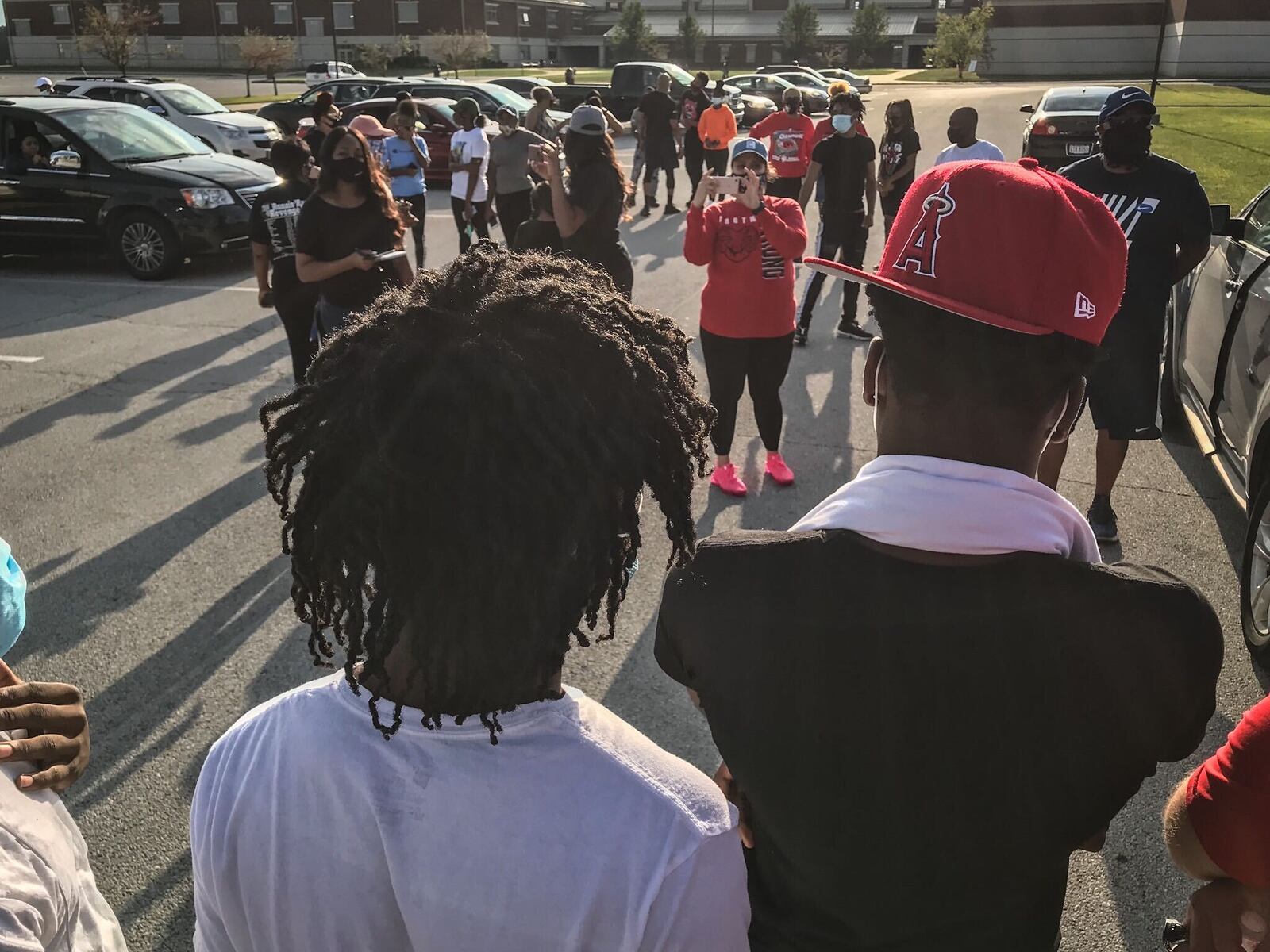 A couple of dozen Trotwood Madison High School parents met Monday afternoon in the parking lot of the school to discuss the school’s decision to opt out of fall sports because of COVID-19.