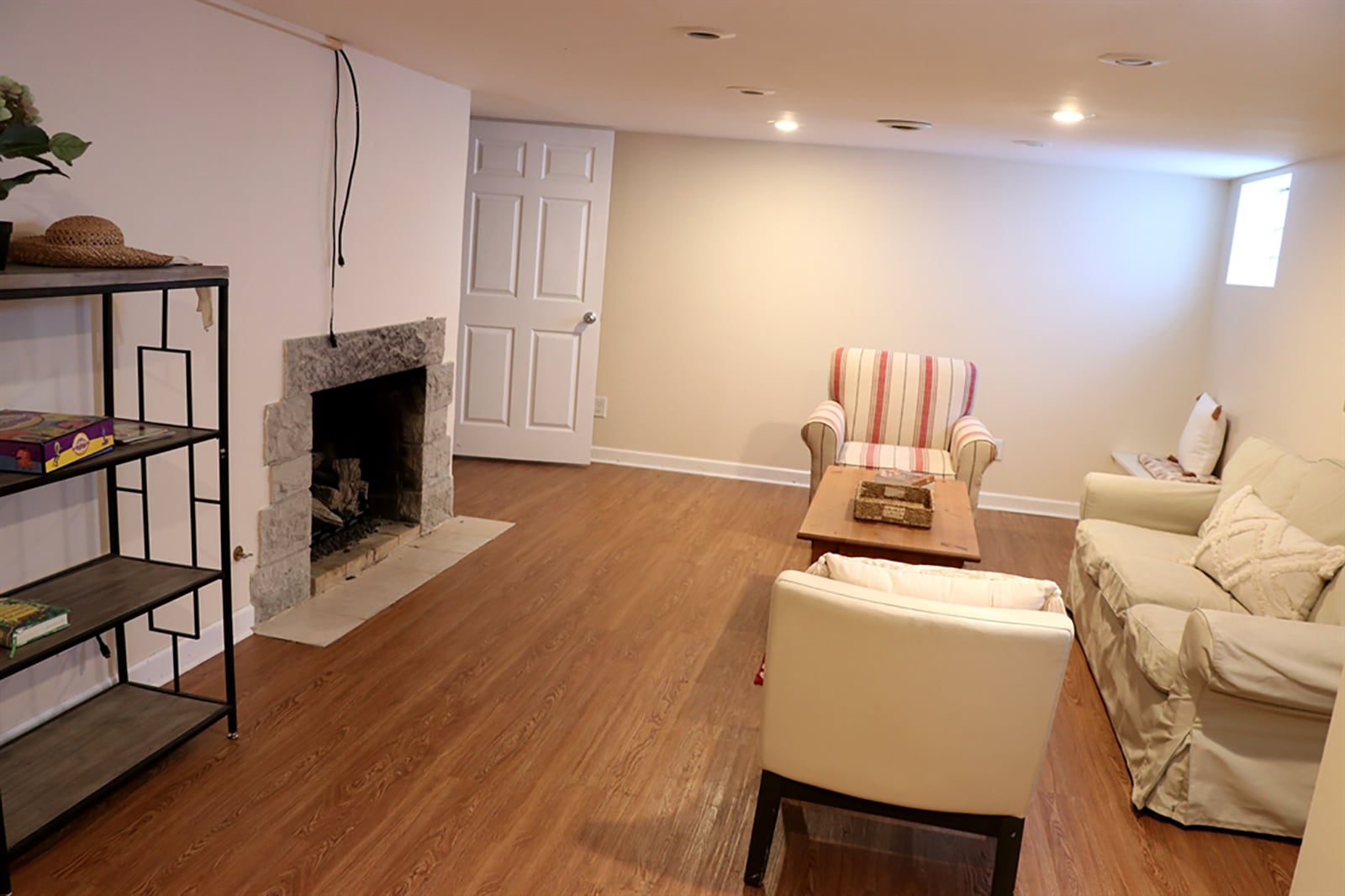 In the finished basement, a family room includes a stone fireplace, glass-block windows and wood-laminate flooring. CONTRIBUTED PHOTO BY KATHY TYLER