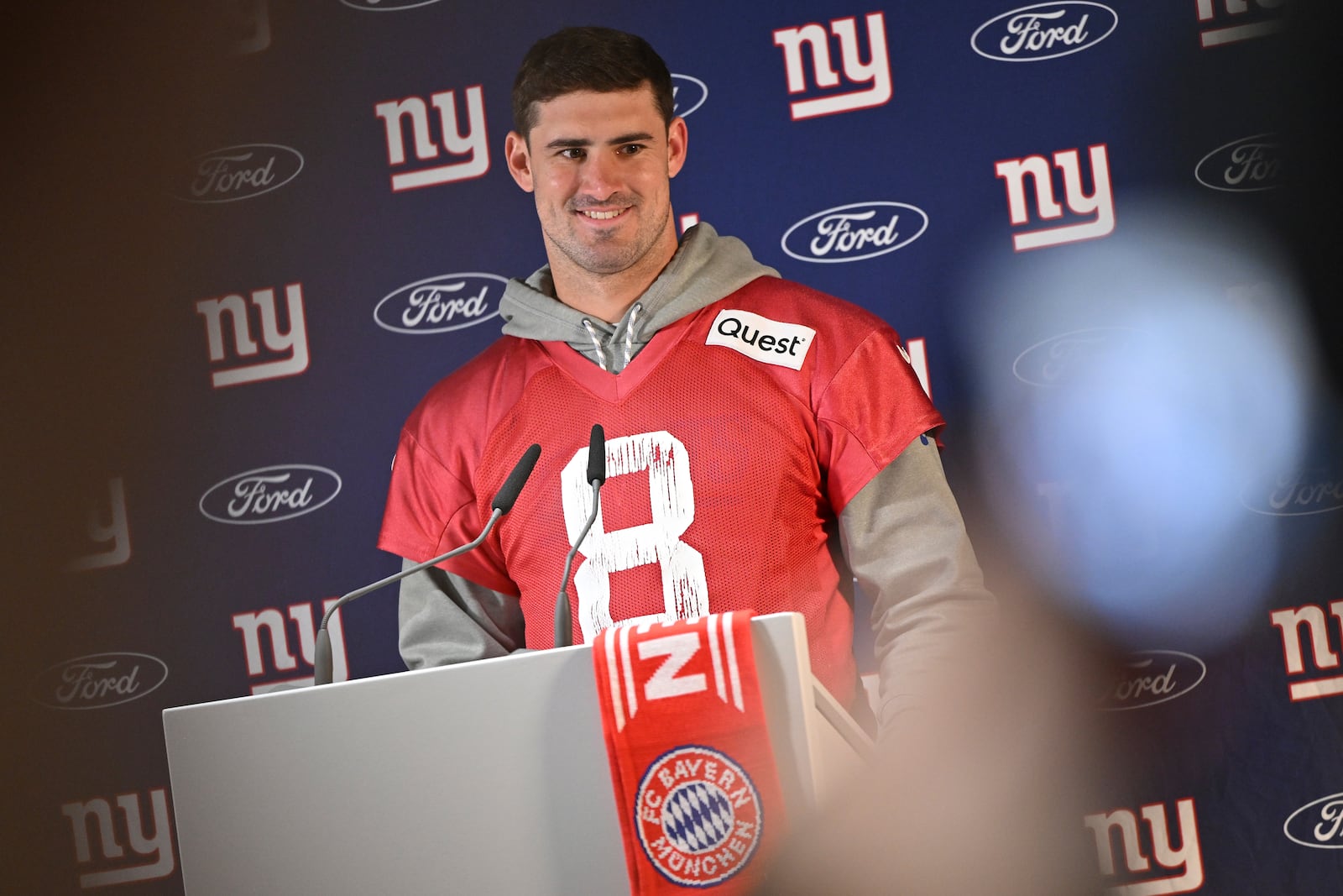 New York Giants quarterback Daniel Jones (8) attends a news conference after a practice session in Munich, Germany, Friday, Nov. 8, 2024. The New York Giants are set to play the Carolina Panthers in an NFL game at the Allianz Arena in Munich on Sunday. (AP Photo/Lennart Preiss)