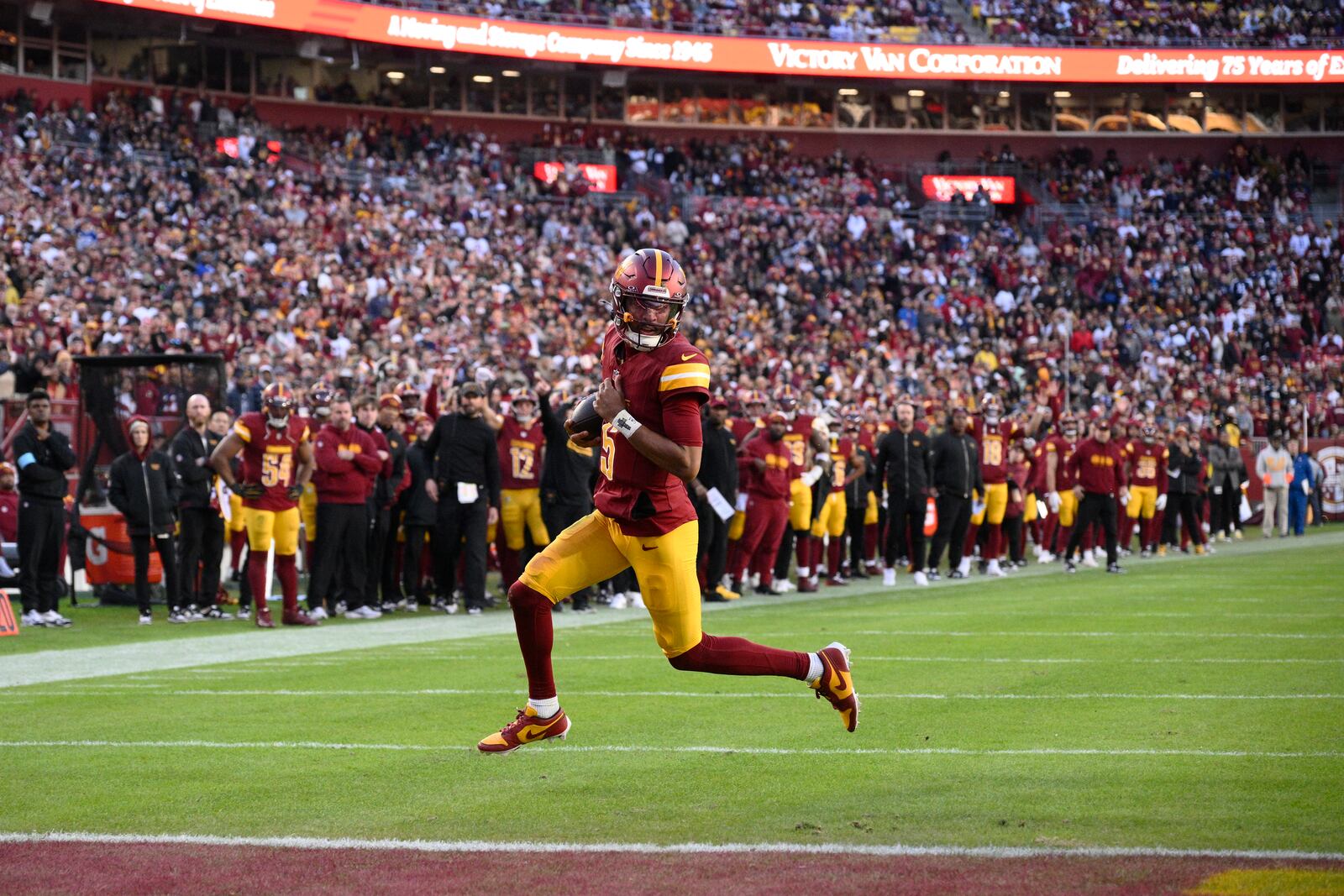 Washington Commanders quarterback Jayden Daniels (5) scores on a 2-point conversion attempt during the second half of an NFL football game against the Dallas Cowboys, Sunday, Nov. 24, 2024, in Landover, Md. (AP Photo/Nick Wass)