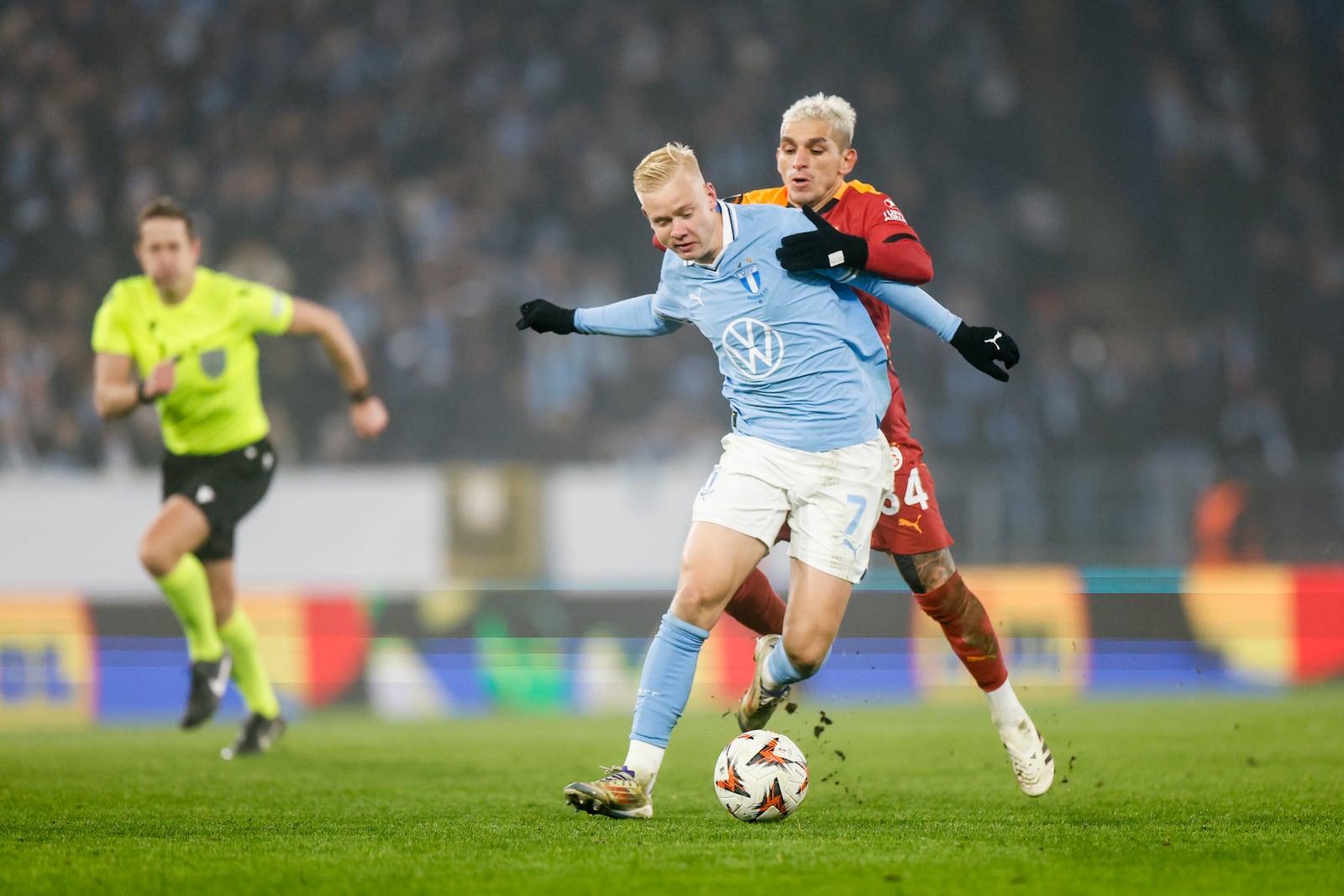 Malmö's Otto Rosengren (left) is challenged by Galatasaray's Lucas Torreira during the Europa League opening phase soccer match between Malmo FF and Galatasaray SK at the Malmo New Stadium in Malmo, Sweden, Thursday, Dec. 12, 2024. (Andreas Hillergren/TT News Agency via AP)