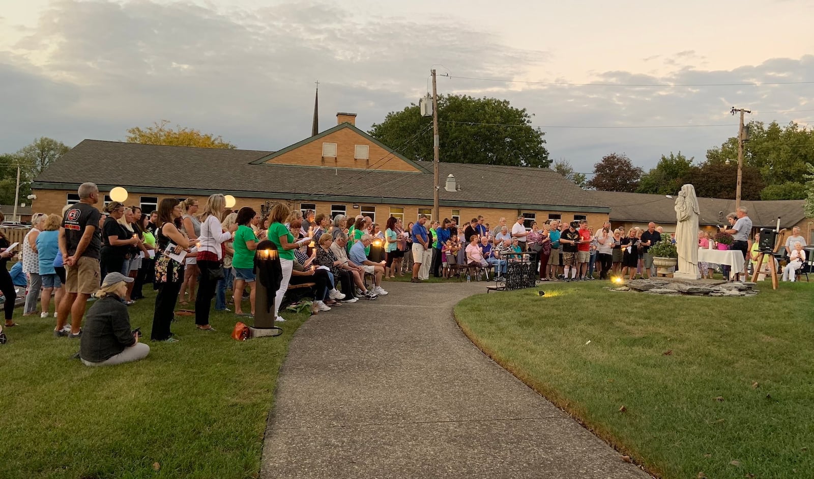 Family, friends and community members were holding candles, singing and praying for Cheryl Coker to be found during a vigil at St. Helen's Parish on Oct. 2, 2019, on the one-year anniversary of the 46-year-old Riverside woman’s disappearance.