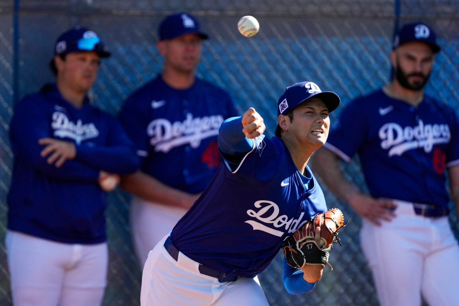 Los Angeles Dodgers two-way player Shohei Ohtani (17) works out during spring training baseball practice, Saturday, Feb. 15, 2025, in Phoenix. (AP Photo/Ashley Landis)