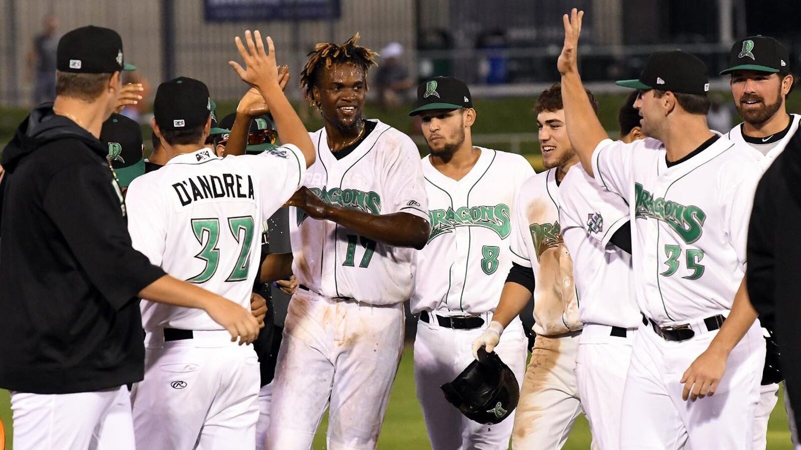 Dayton’s Mariel Bautista is congratulated by Dragons teammates after driving in the winning run against the visiting Bowling Green Hot Rods on Thursday, Aug. 1, 2019. NICK FALZERANO / CONTRIBUTED