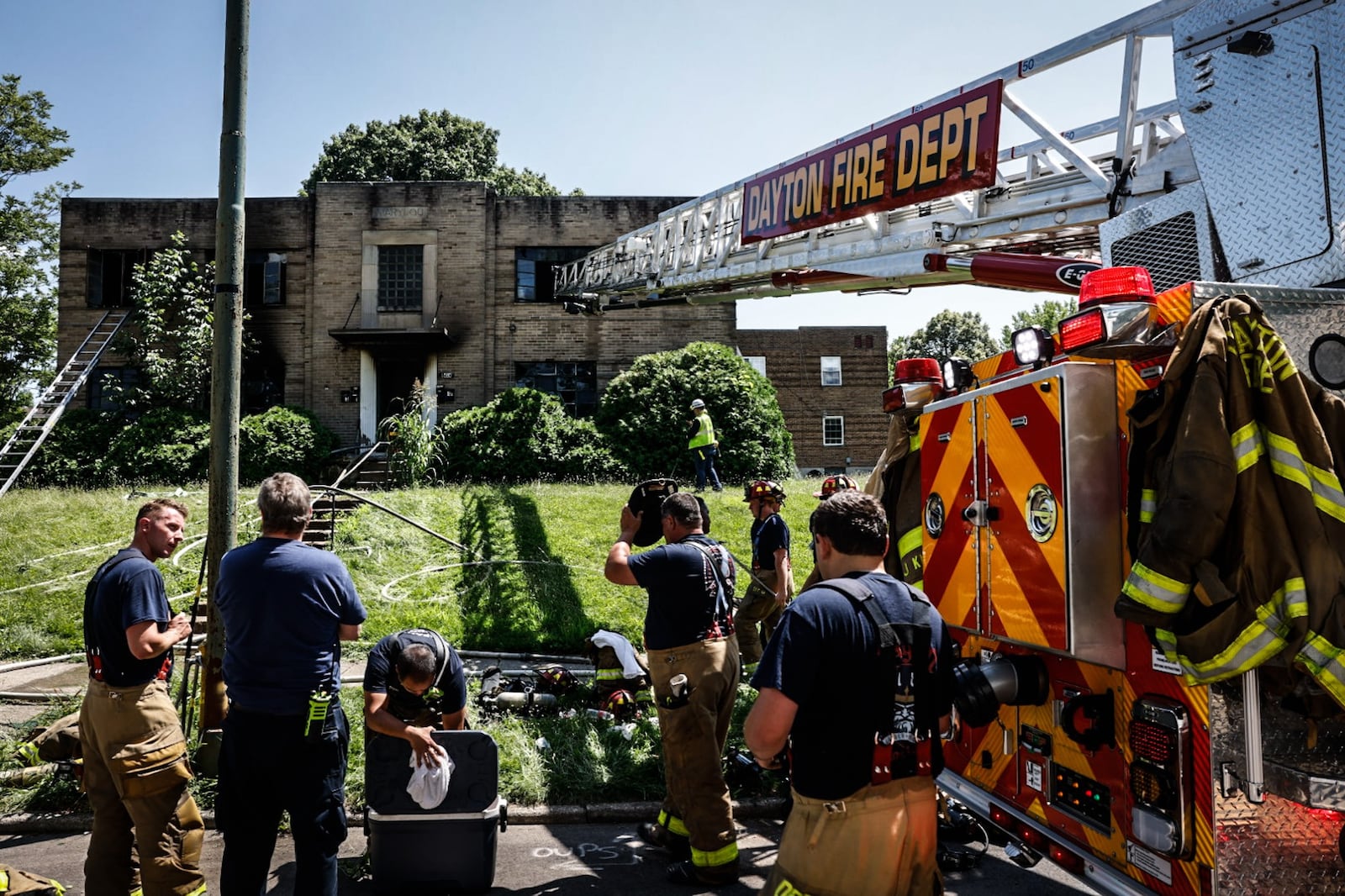 With temperatures near 90 degrees, Dayton firefighters battled the heat Friday, July 14, 2023, along with an apartment fire on Huffman Avenue. One unit in the four-unit building was occupied with one person displaced. No one was injured. JIM NOELKER/STAFF