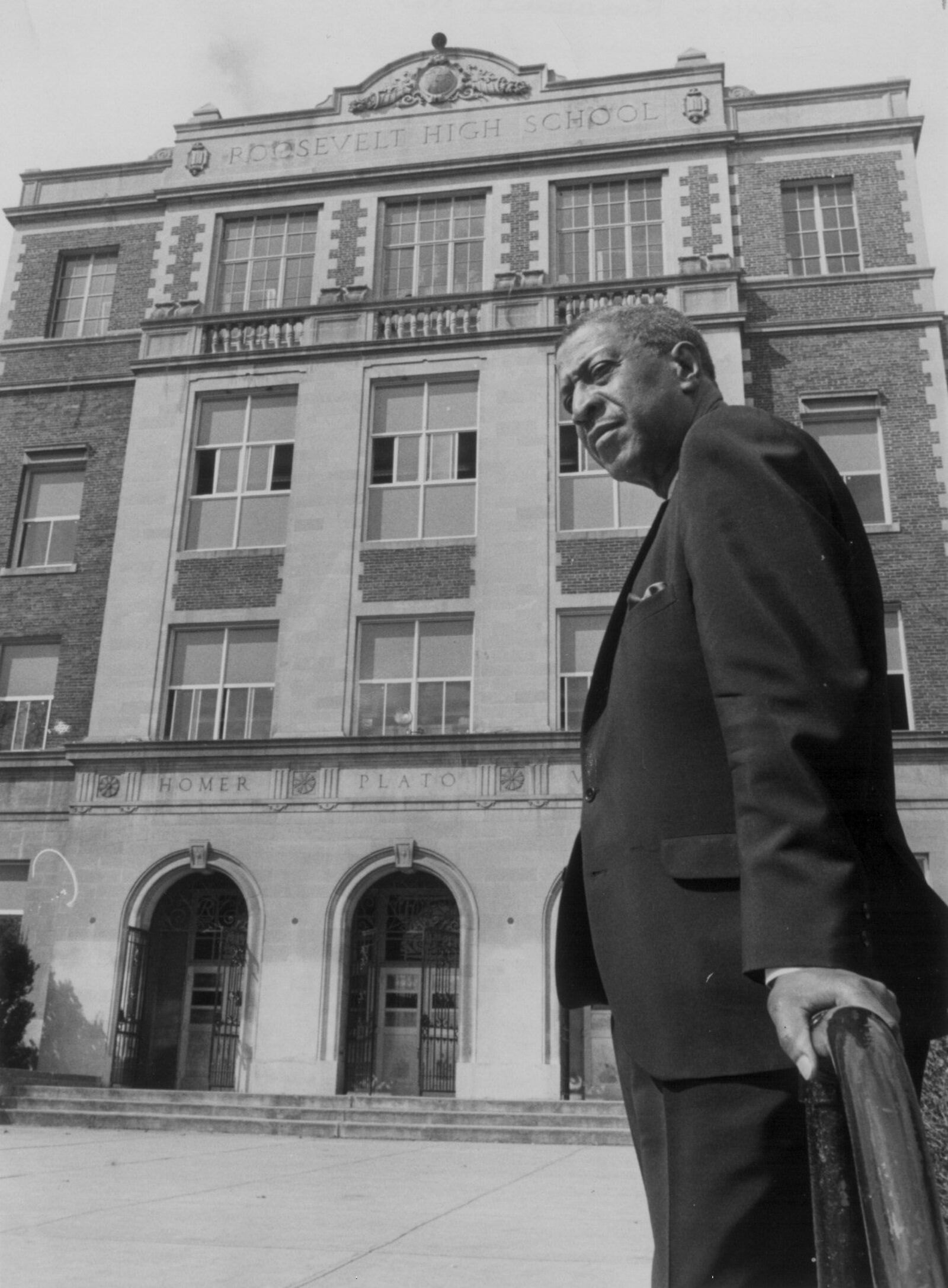 In 1968, William Reed Cummings was named principal of Roosevelt High School and was the first black to hold that post at the school. In this 1969 photo he is standing in front of the school after new windows were installed. Prior to his appointment, he had been assistant principal at Roosevelt for 10 years. He also taught at Dunbar High School for 13 years. Mr. Cummings suffered a stroke in 1969 and retired from education. He died in 1983 at the age of 78.