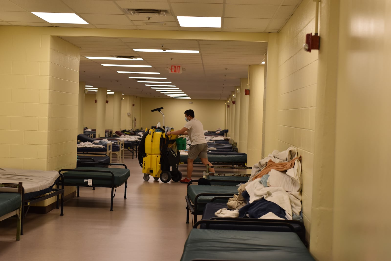 A worker pushes a cleaning cart in a dorm at the Shelter for Women and Families run by St. Vincent de Paul Society, Dayton. CORNELIUS FROLIK / STAFF