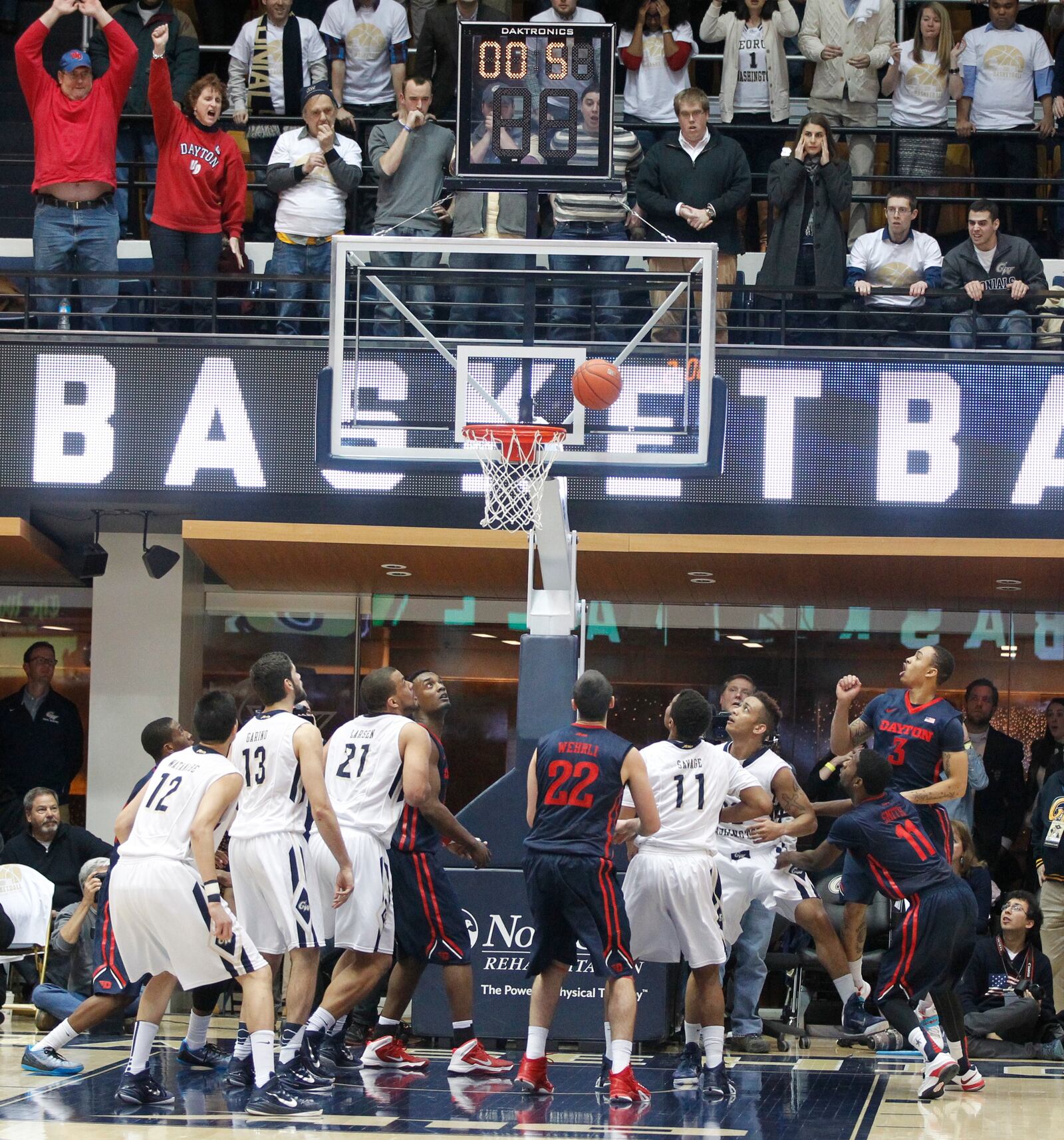 Dayton and George Washington players watch as Joe McDonald's shot at the buzzer falls through the net in overtime on Friday, Feb. 6, 2015, at the Smith Center in Washington. David Jablonski/Staff