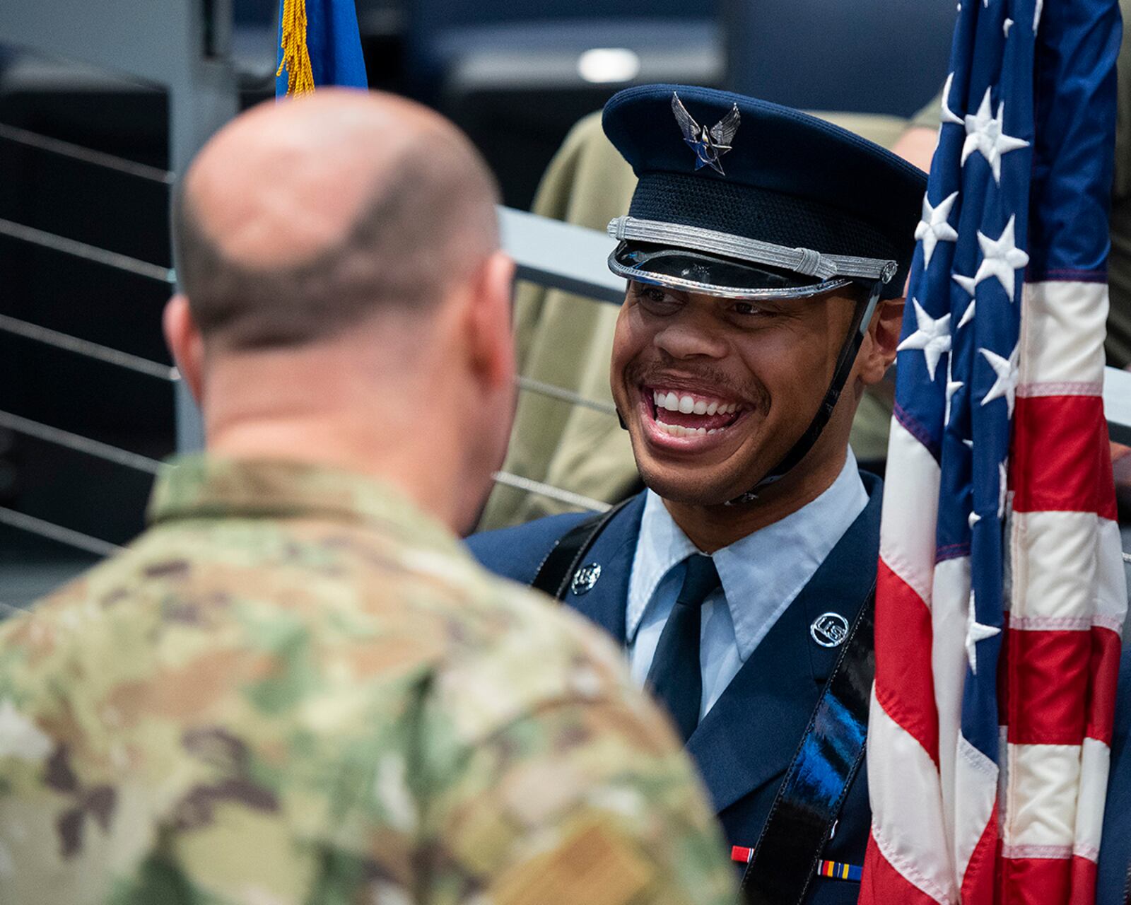 Senior Airman McKinley Gillis, Wright-Patterson Air Force Base guardsman, laughs with Col. Patrick Miller, 88th Air Base Wing and Wright-Patterson Air Force Base commander March 16 prior to the Honor Guard taking part in the opening ceremony of the NCAA men’s basketball tournament First Four game between Wright State and Bryant. The base was also represented in the opening ceremony by a group of Airmen unfurling a large American flag. U.S. AIR FORCE PHOTO/R.J. ORIEZ