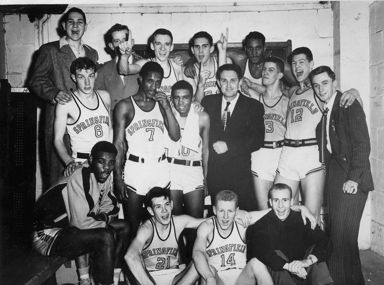 In a photo reminiscent of the movie Hoosiers, an elated Elwood Pitzer and his team pose for a shot following their state championship win in 1950. Seated from left are Chrystal “Boo” Ellis, Jack Sallee, Lamar Kilgore and Joe Cahoon. Middle row from left. Earl Fritts, Bob “Hutchins, Bob Bronston, Coach Elwood Pitzer, Bill Goettman, Don DeJong, Dick Dillahunt. Back row: Manager Dick Freed, Manager Dick Parsell, Bill McKaig, Roger Crabtree and Nat Murphy.
