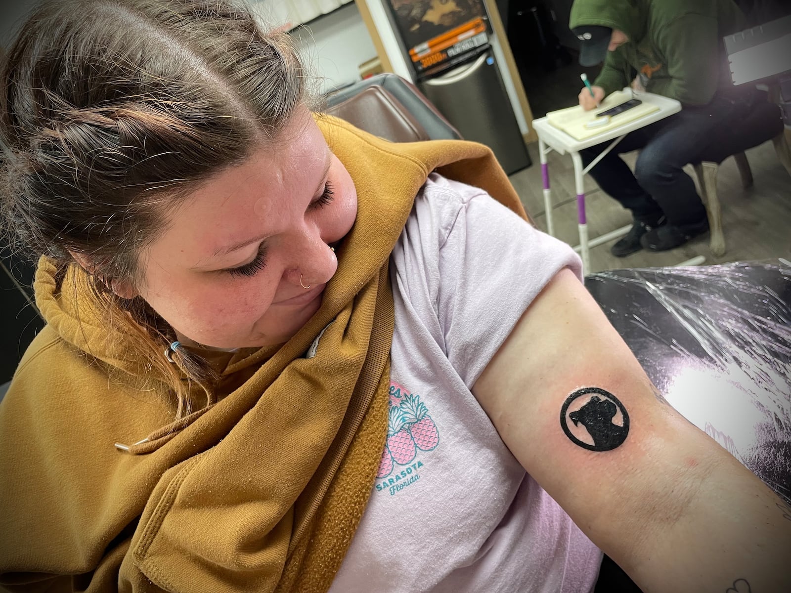 Kaitlyn Daugherty of Dayton is one of five people that now have The Food Pitt logo tattooed on her. She can now get free burgers for life. NATALIE JONES/STAFF