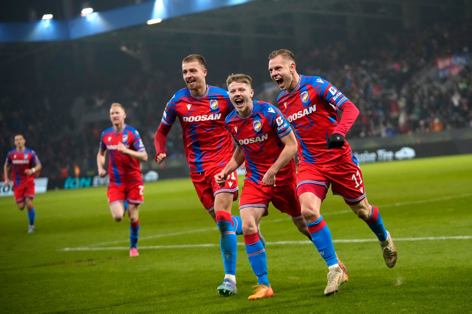 Plzen's Matej Vydra, right, celebrates with teammates after scoring his side's opening goal during the Europa League soccer match between Viktoria Plzen and Manchester United at the Doosan Arena in Plzen, Czech Republic, Thursday, Dec. 12, 2024. (AP Photo/Petr David Josek)