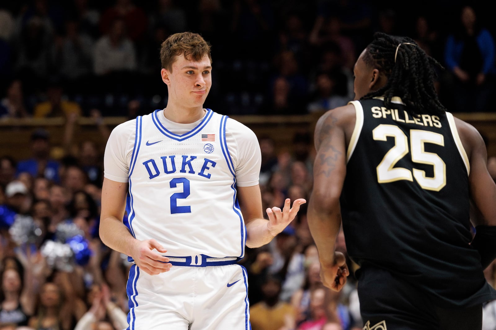 Duke's Cooper Flagg (2) reacts ahead of Wake Forest's Tre'Von Spillers (25) after hitting a 3-point basket during the second half of an NCAA college basketball game in Durham, N.C., Monday, March 3, 2025. (AP Photo/Ben McKeown)