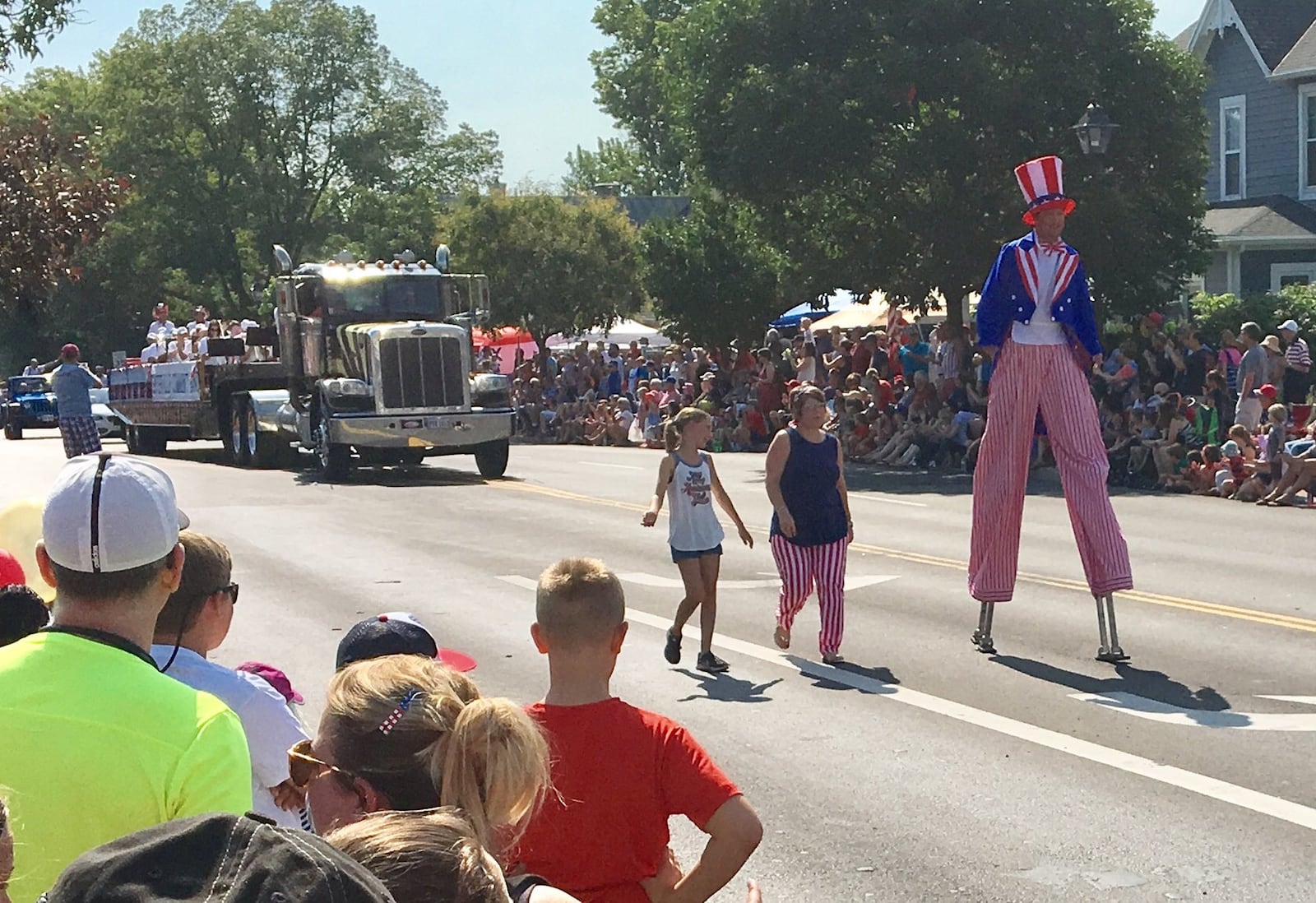 A man in American garb on stilts walks in the 4th of July parade at Centerville’s annual Americana Festival. The parade included more than 120 acts including numerous bands and floats, according to the festival.