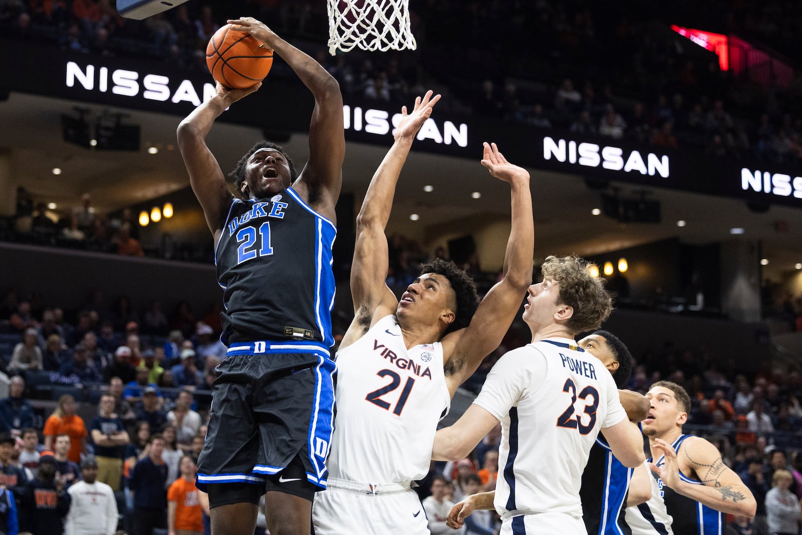 Duke center Patrick Ngongba II (21) shoots the ball over Virginia forward Anthony Robinson (21) during the second half of an NCAA college basketball game, Monday, Feb. 17, 2025, in Charlottesville, Va. (AP Photo/Mike Kropf)