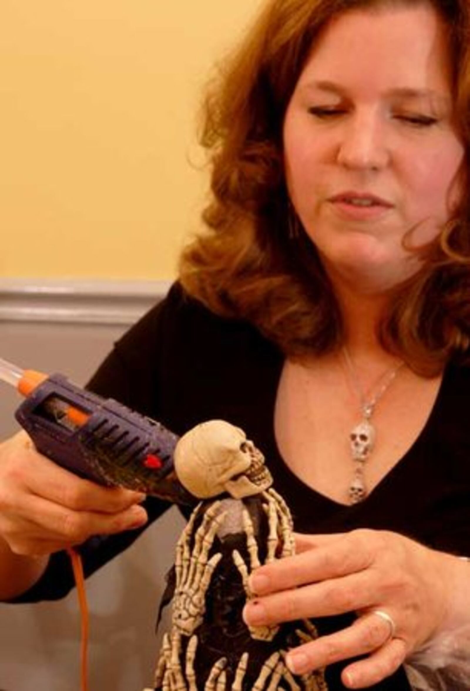 Jana Collier adds a skull to a cone as crafters work on Halloween decorations, Saturday, October 11, 2008.