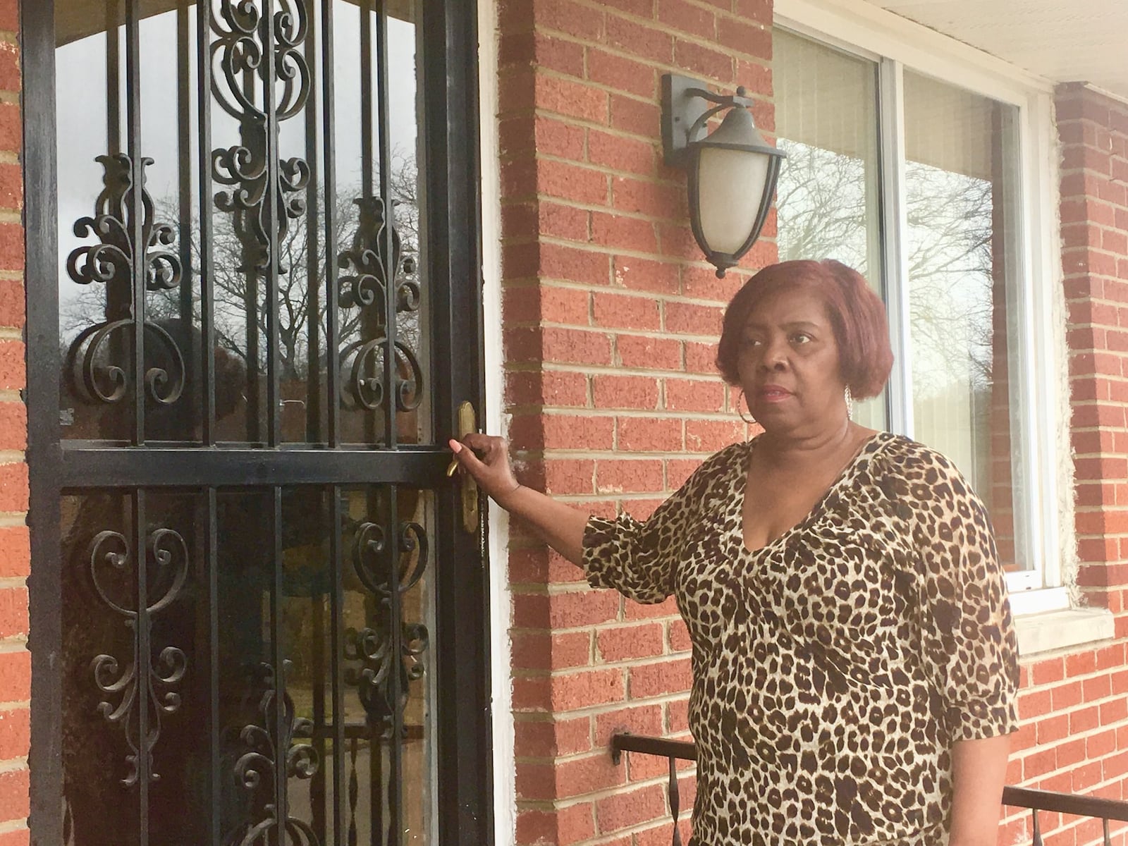 Wanda Dean stands on the porch of her Parkwood Drive home in the Riverdale neighborhood of Dayton, Wednesday, Feb. 21, 2018. She’s frustrated with a low appraisal value her duplex received as she’s tried to sell it. Her neighborhood is one that data shows suffers from modern-day redlining. KATIE WEDELL/STAFF