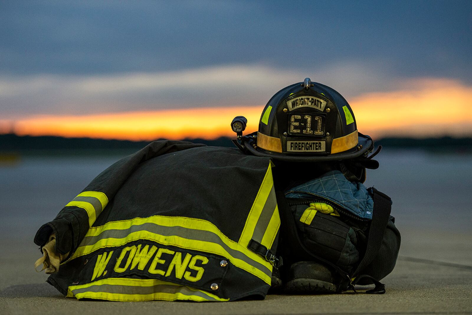 Bunker gear sits staged just outside the bays at Fire Station 1 during sunset June 23 at Wright-Patterson Air Force Base. The base has three stations strategically located to ensure a response time of 5 minutes or less when calls for help arrive. U.S. AIR FORCE PHOTO/WESLEY FARNSWORTH