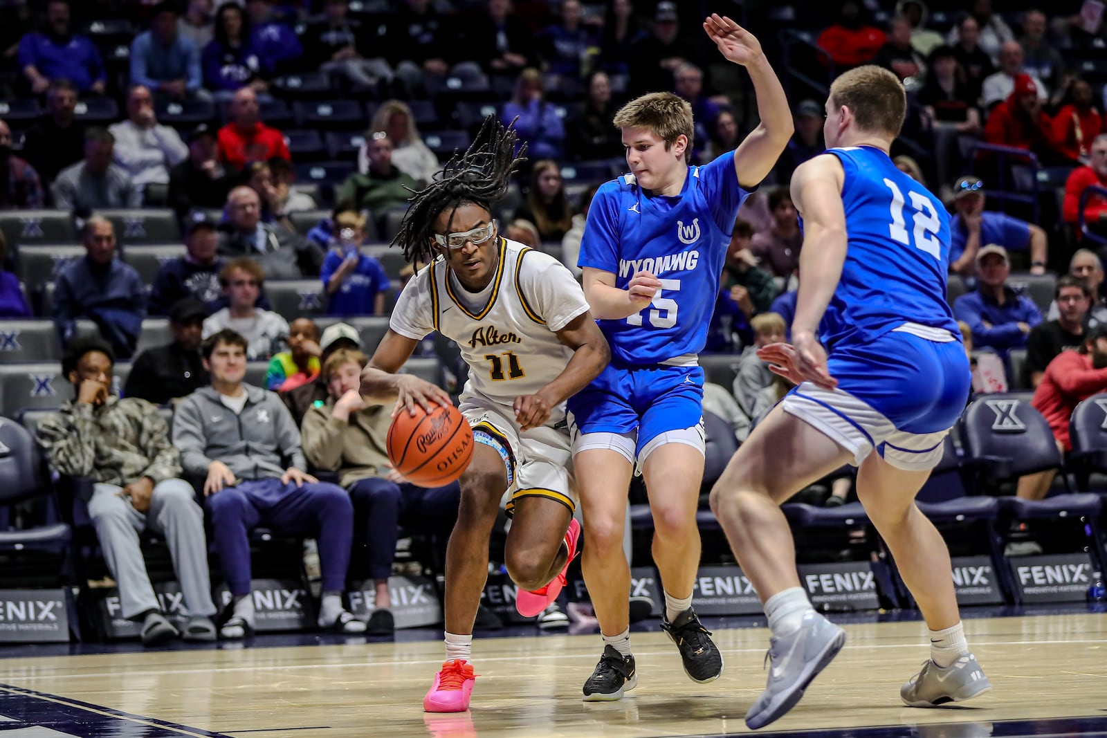 Alter's Naceive Fenton, Jr. drives past Cincinnati Wyoming defenders during a Division IV regional final game on Sunday afternoon at the Xavier University Cintas Center. Michael Cooper/STAFF