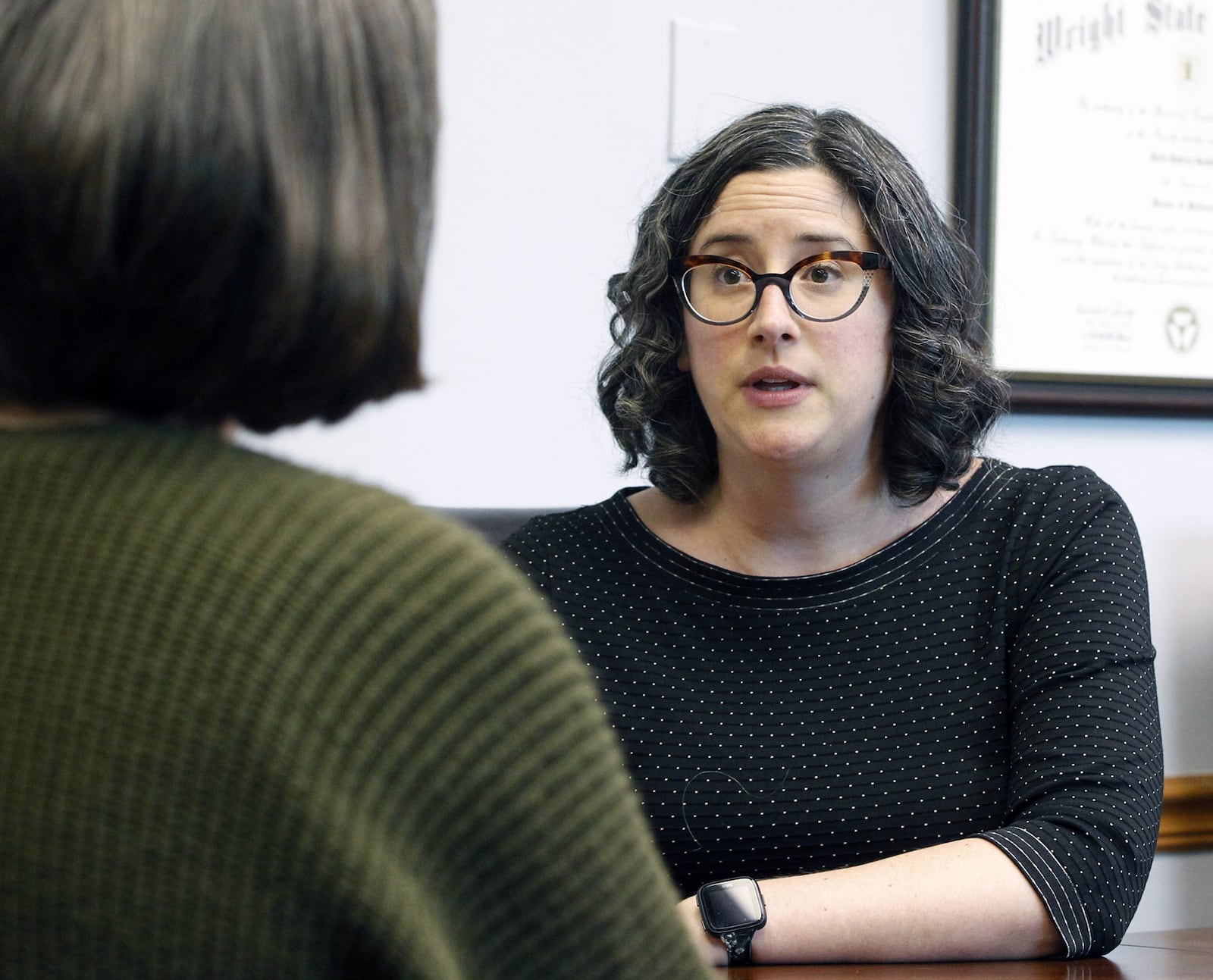 Dr. Racheal Johnson, D.O., chief resident of Wright State University Psychiatry, left, talks with Dr. Allison Cowan, M.D., medical director, Wright State Psychiatry residency psychotherapy clinic at Elizabeth Place. The clinic offers low-cost appointments with psychiatry residents to help them train and alleviate a shortage of psychiatrists in the Miami Valley. TY GREENLEES / STAFF