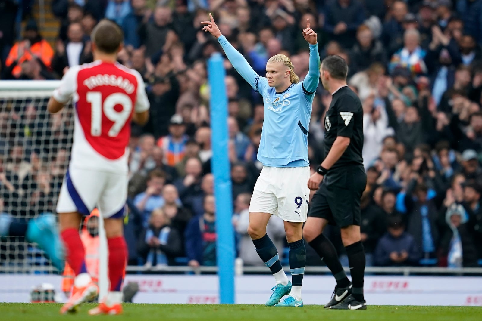 Manchester City's Erling Haaland, center, celebrates after scoring his side's opening goal during the English Premier League soccer match between Manchester City and Arsenal at the Etihad stadium in Manchester, England, Sunday, Sept. 22, 2024. (AP Photo/Dave Thompson)