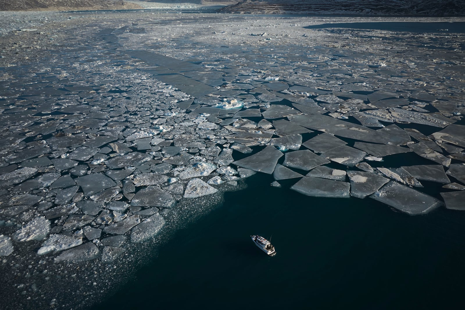 Pieces of ice move through the sea in Qoornoq Island, near Nuuk, Greenland, Monday, Feb. 17, 2025. (AP Photo/Emilio Morenatti)