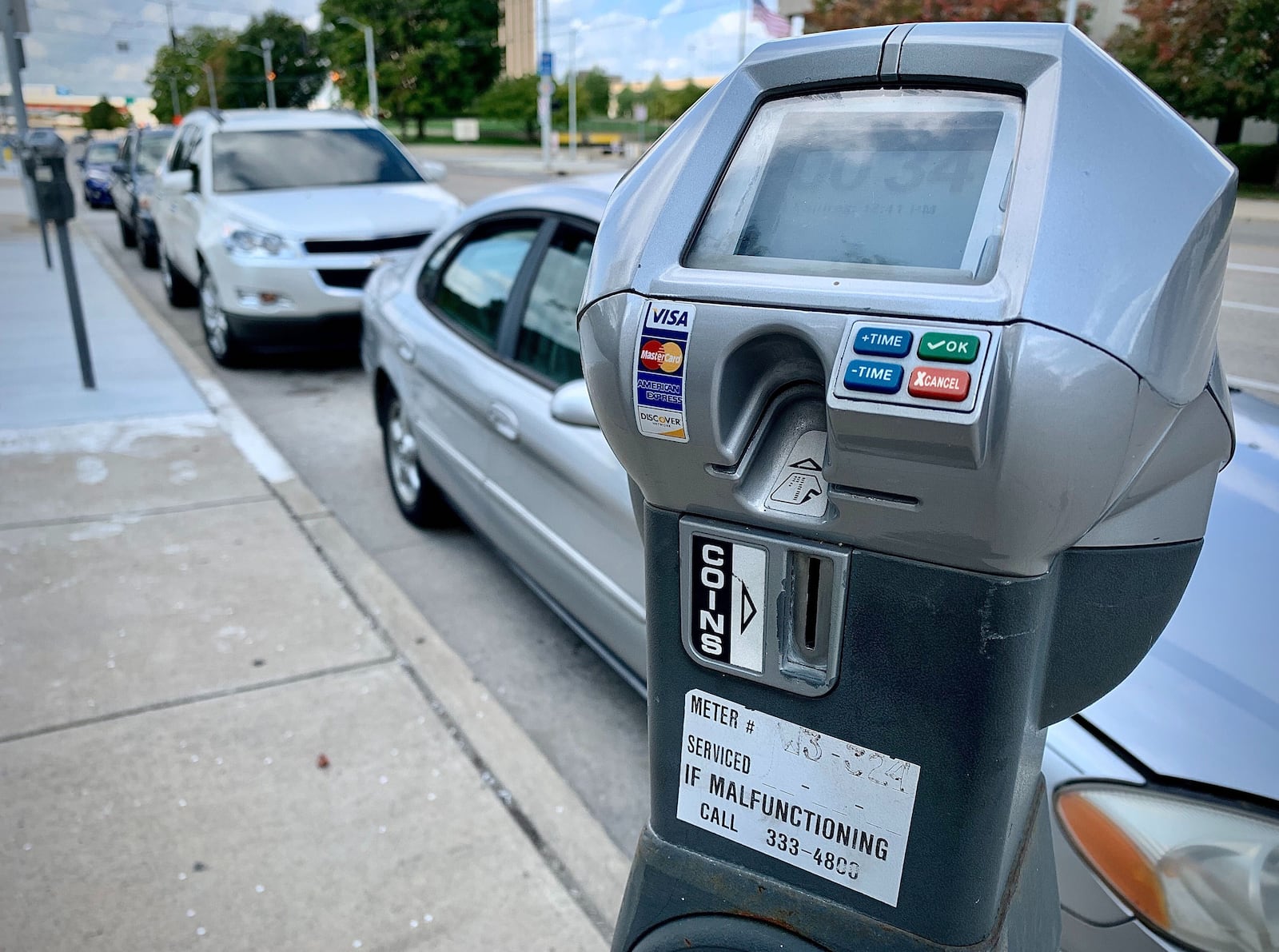 The city of Dayton is planning to launch an app that will let drivers pay for parking on their phone instead of using a meter. MARSHALL GORBY\STAFF