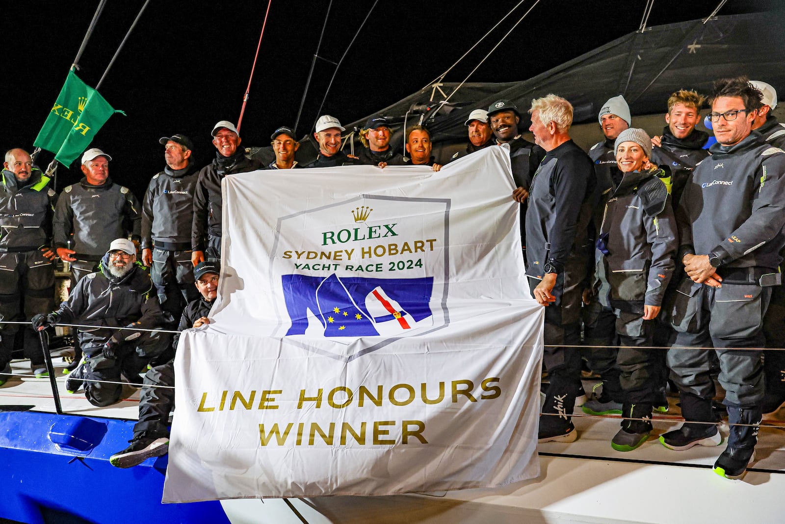 Crew of Law Connect pose for a photo after winning line honours in the Sydney to Hobart yacht race in Hobart, Australia, Saturday, Dec. 28, 2024. (Salty Dingo via AP)