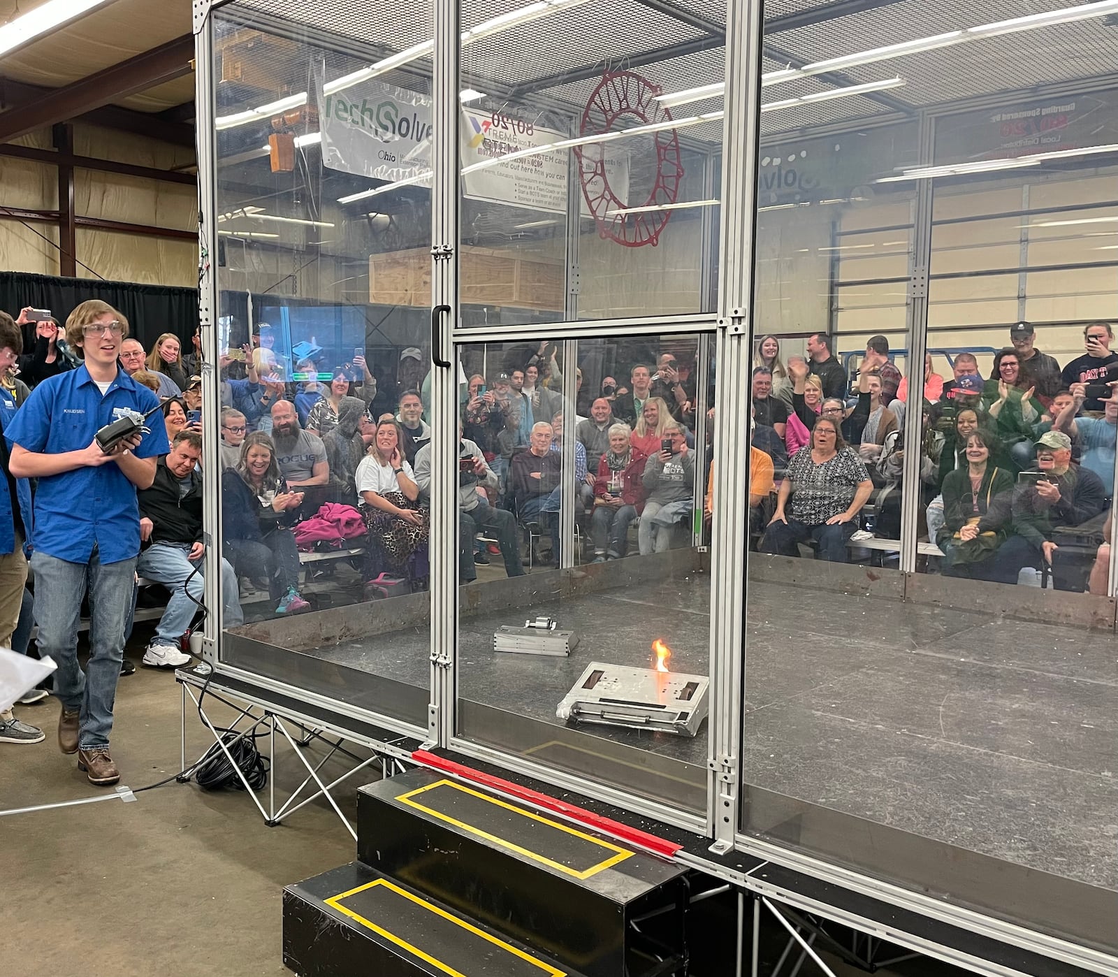 One team's robot caught fire following a battle during Saturday's Xtreme BOTS competition in Dayton. AIMEE HANCOCK