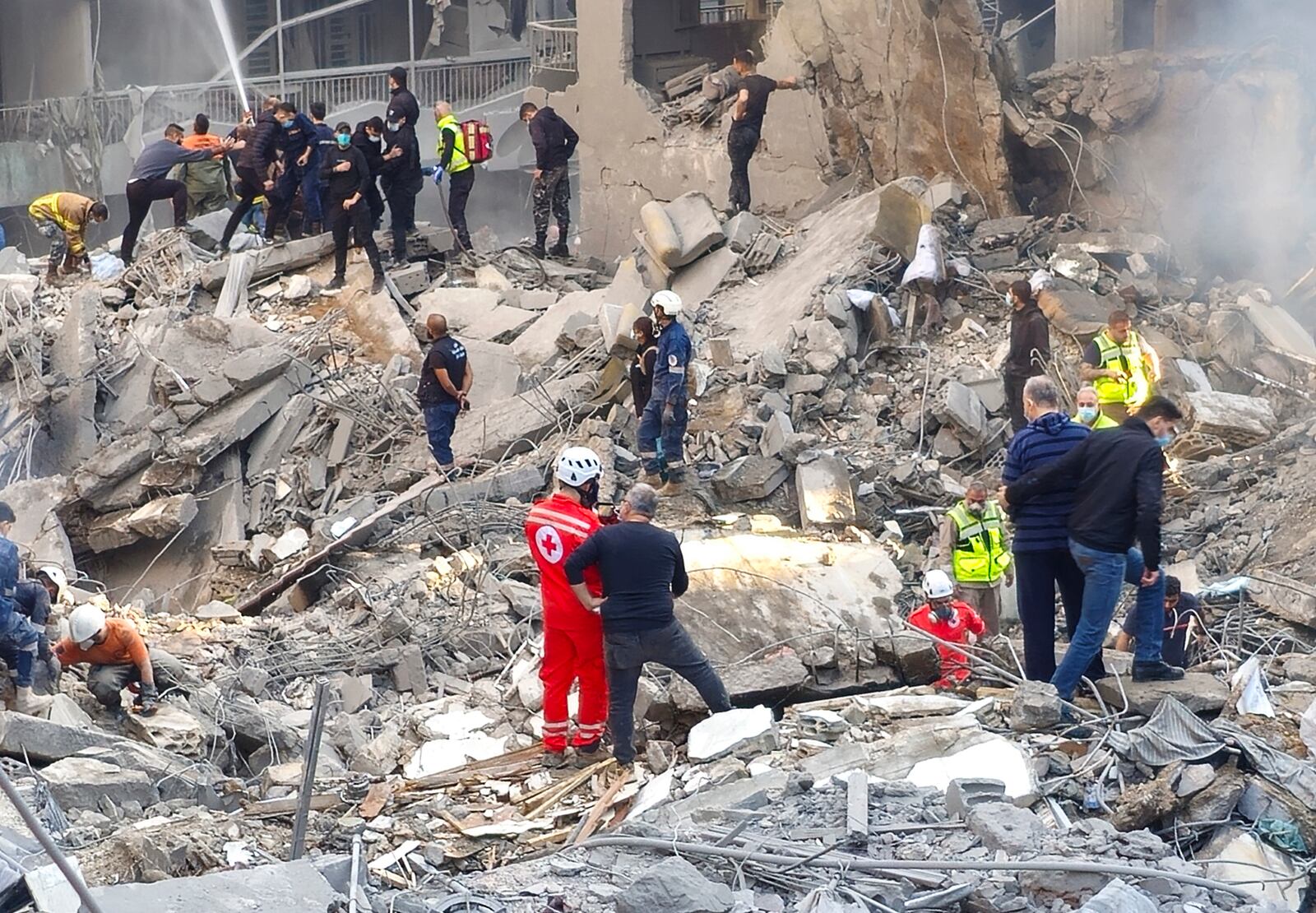 Rescue workers and people search for victims at the site of an Israeli airstrike that hit central Beirut, Lebanon, Saturday, Nov. 23, 2024. (AP Photo/Hassan Ammar)