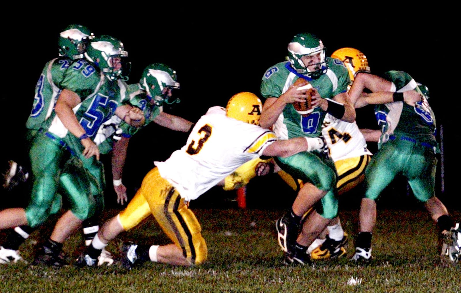 Alter senior Tim Cableck (3) goes after the Eagles Quarterback Kurt Hess (6) behind the line of scrimmage as the Chaminade-Julienne Eagles play the Alter High School Knights, Friday, October 26, 2007.