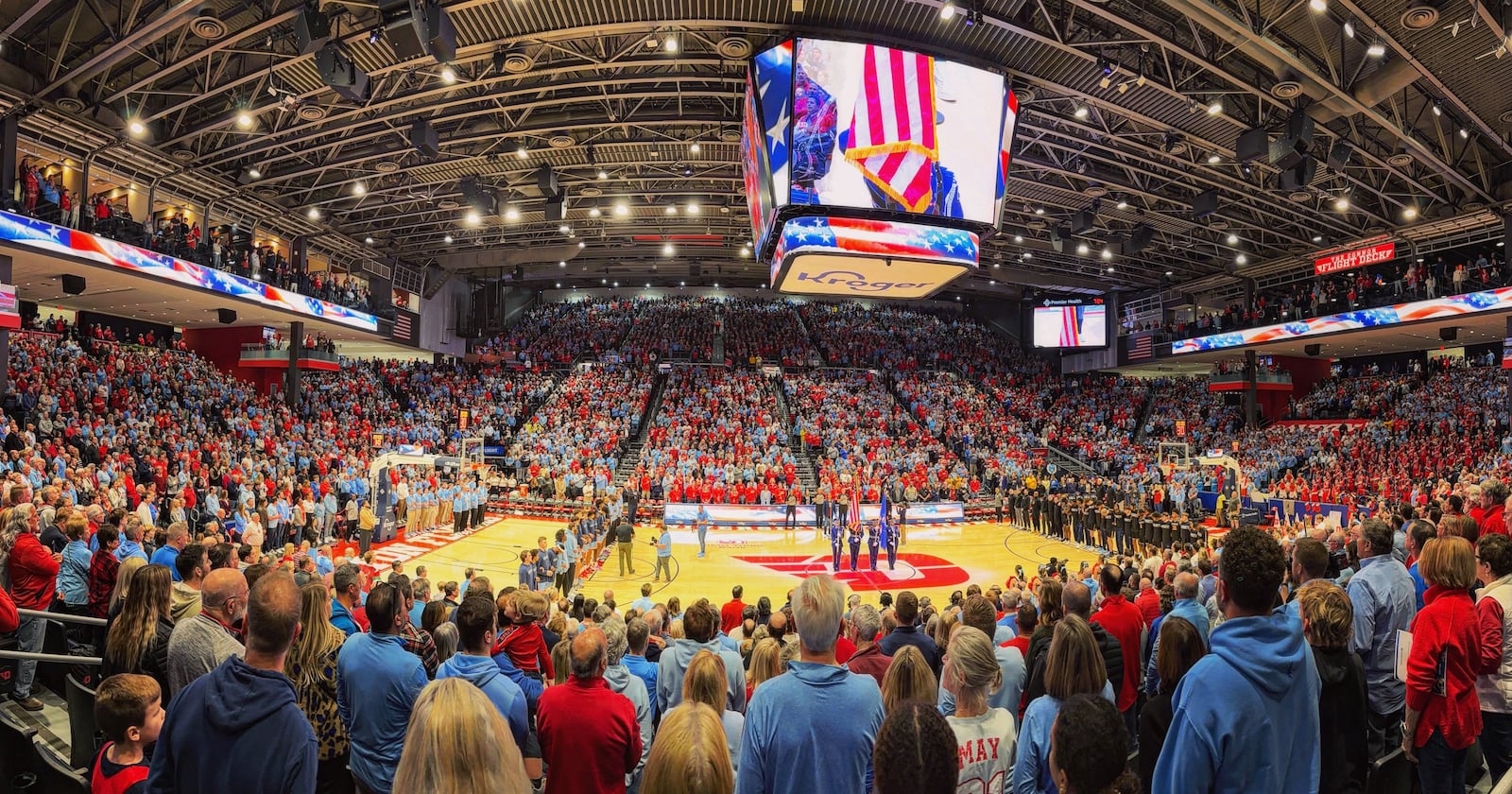 Dayton and Marquette stand for the national anthem on Saturday, Dec. 14, 2024, at UD Arena. David Jablonski/Staff