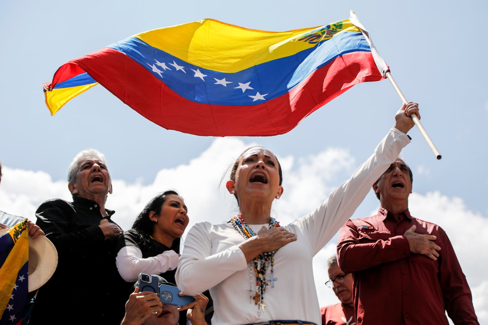 FILE - Opposition leader Maria Corina Machado waves a Venezuelan national flag during a rally to protest official results that declared President Nicolas Maduro the winner of the July presidential election, in Caracas, Venezuela, Aug. 17, 2024. (AP Photo/Cristian Hernandez, File)