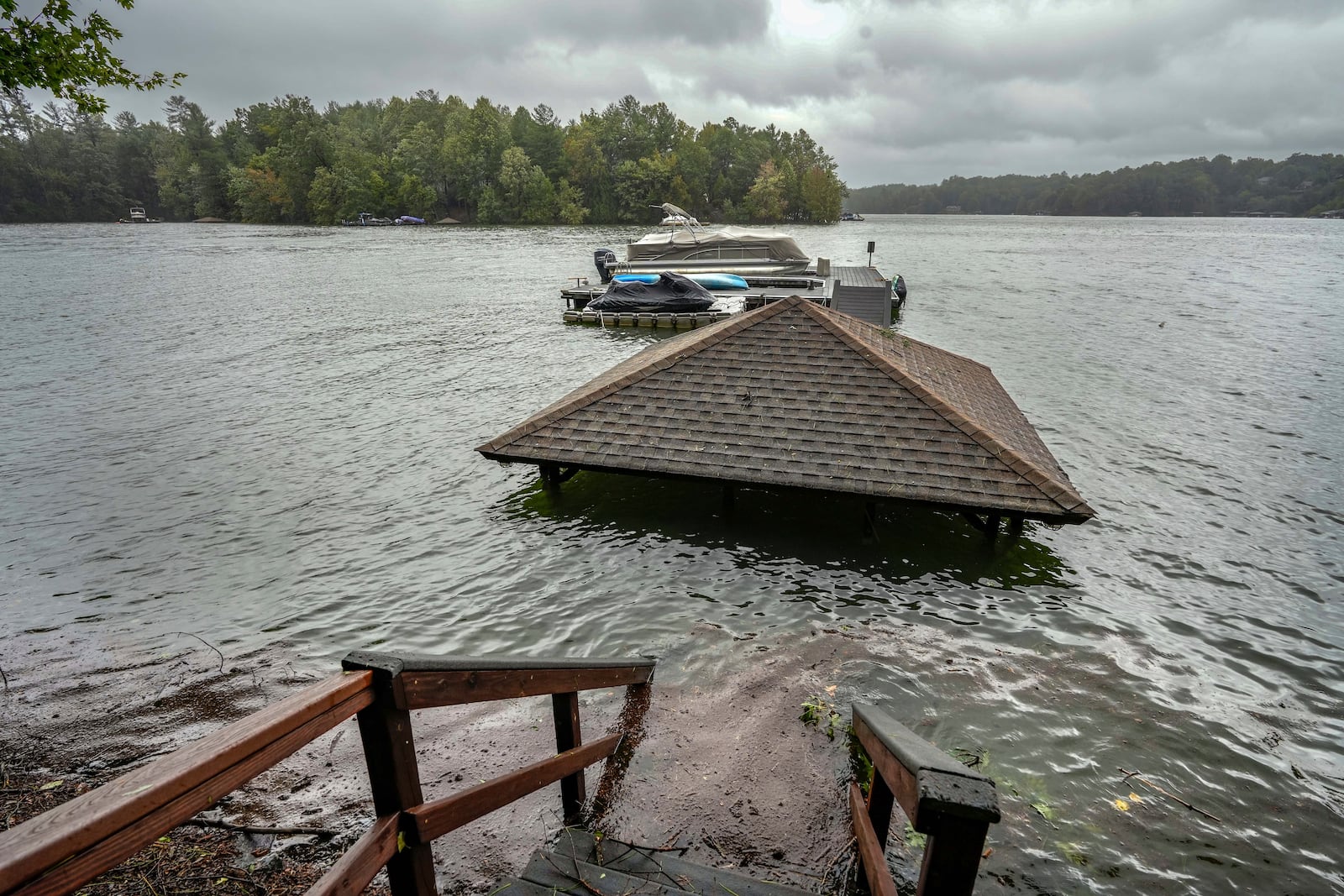 Torrential rain from Hurricane Helene has caused lake levels to rise on Lake James, resulting in flooded docks and gazebos, Friday, Sept. 27, 2024 in Morganton, N.C. (AP Photo/Kathy Kmonicek)