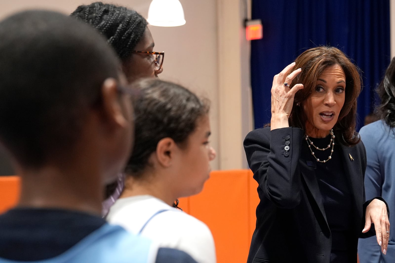 Democratic presidential nominee Vice President Kamala Harris, right, speaks with young basketball players before a community rally at the Alan Horwitz "Sixth Man" Center, Sunday, Oct. 27, 2024, in Philadelphia. (AP Photo/Susan Walsh)