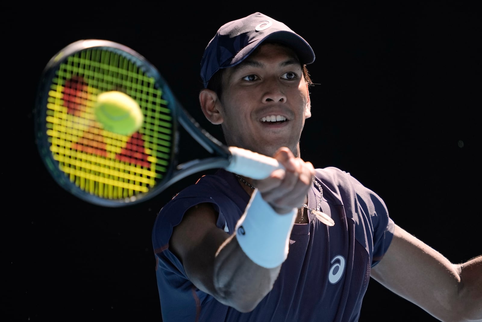 Kasidit Samrej of Thailand plays a forehand return to Daniil Medvedev of Russia during their first round match at the Australian Open tennis championship in Melbourne, Australia, Tuesday, Jan. 14, 2025. (AP Photo/Ng Han Guan)