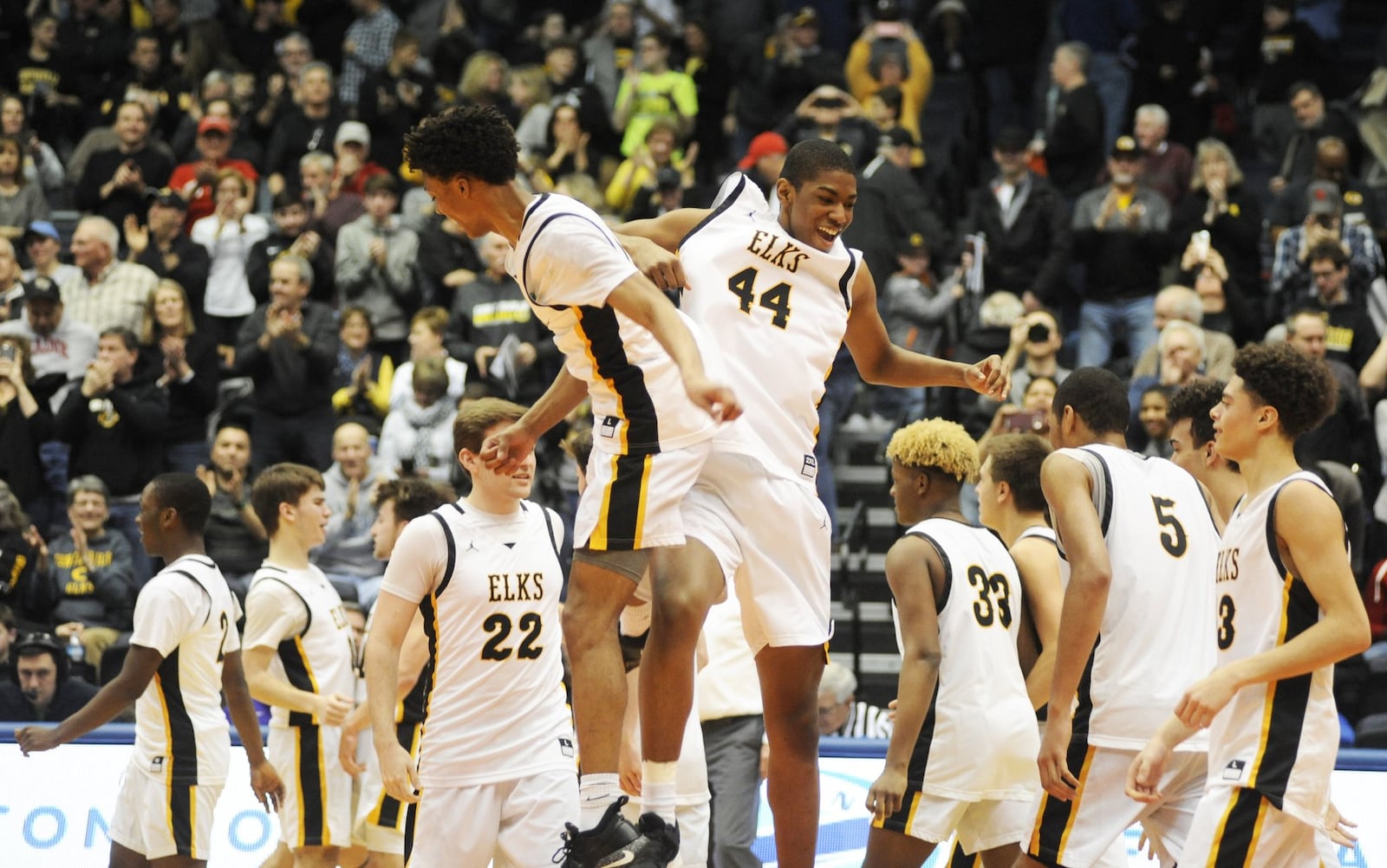 Elks Kaleb Mitchell (middle left) and Mo Njie take to the air to celebrate. Centerville defeated Mason 49-43 in a boys high school basketball D-I district final at UD Arena on Saturday, March 9, 2019. MARC PENDLETON / STAFF