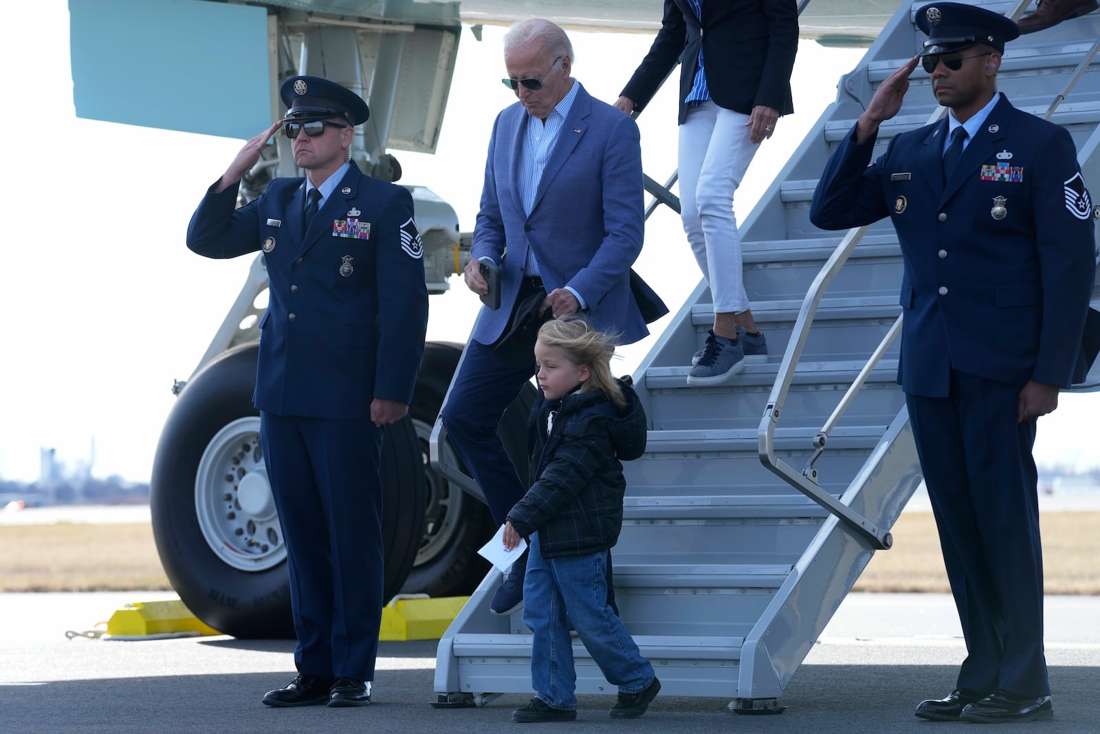 President Joe Biden, holding the hand of his grandson Beau Biden, walks down the steps of Air Force One at Philadelphia International Airport in Philadelphia, Tuesday, Dec. 31, 2024, as they return to Wilmington, Del., following their vacation in the U.S. Virgin Islands.(AP Photo/Susan Walsh)