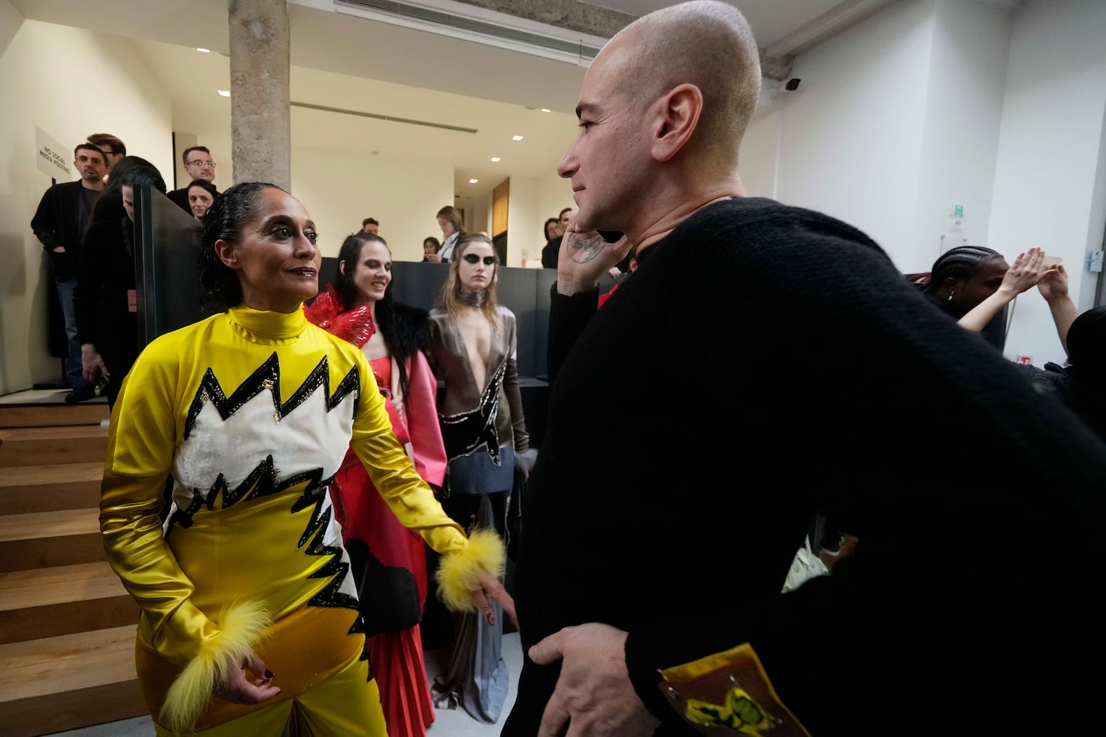 Fashion designer Francesco Risso talks with actress Tracee Ellis Ross in the backstage prior to a Marni Fall/Winter 2025-2026 Womenswear fashion show, during the Fashion Week, in Milan, Italy, Wednesday, Feb. 26, 2025. (AP Photo/Luca Bruno)