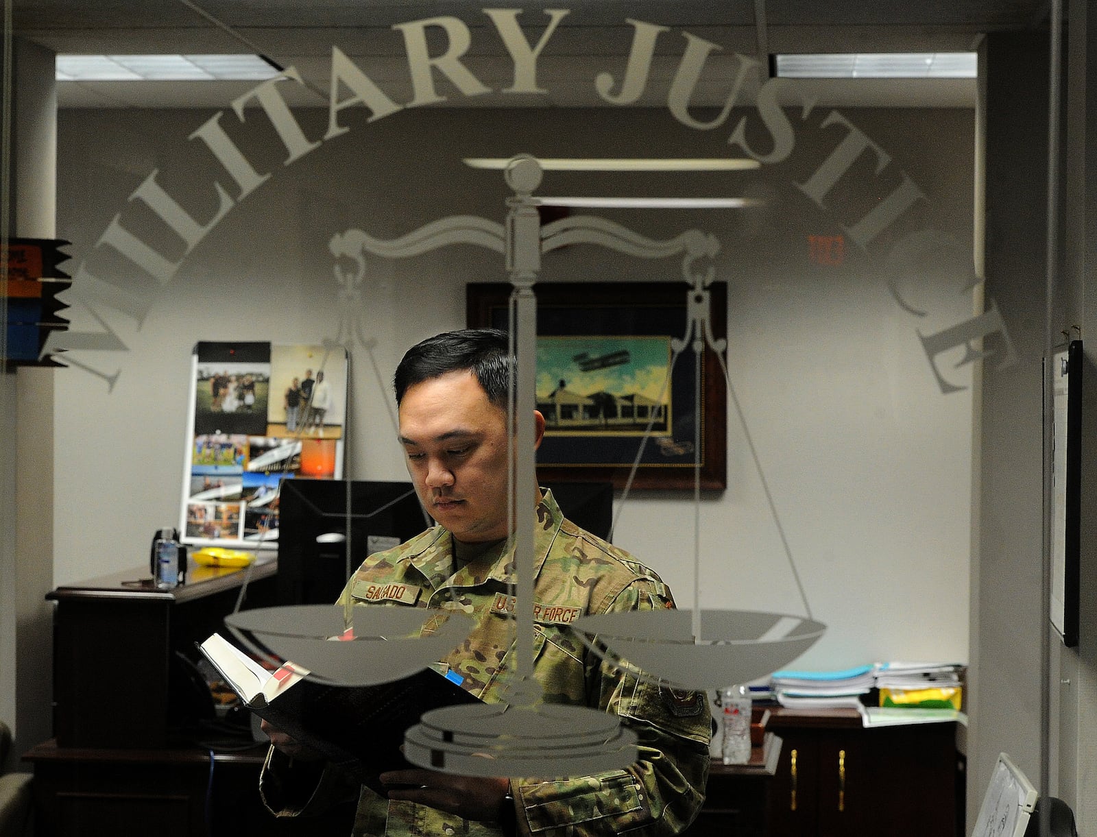 Senior Airman Dox Salgado at work in the Military Justice office at Wright Patterson Air Force Base. MARSHALL GORBY\STAFF