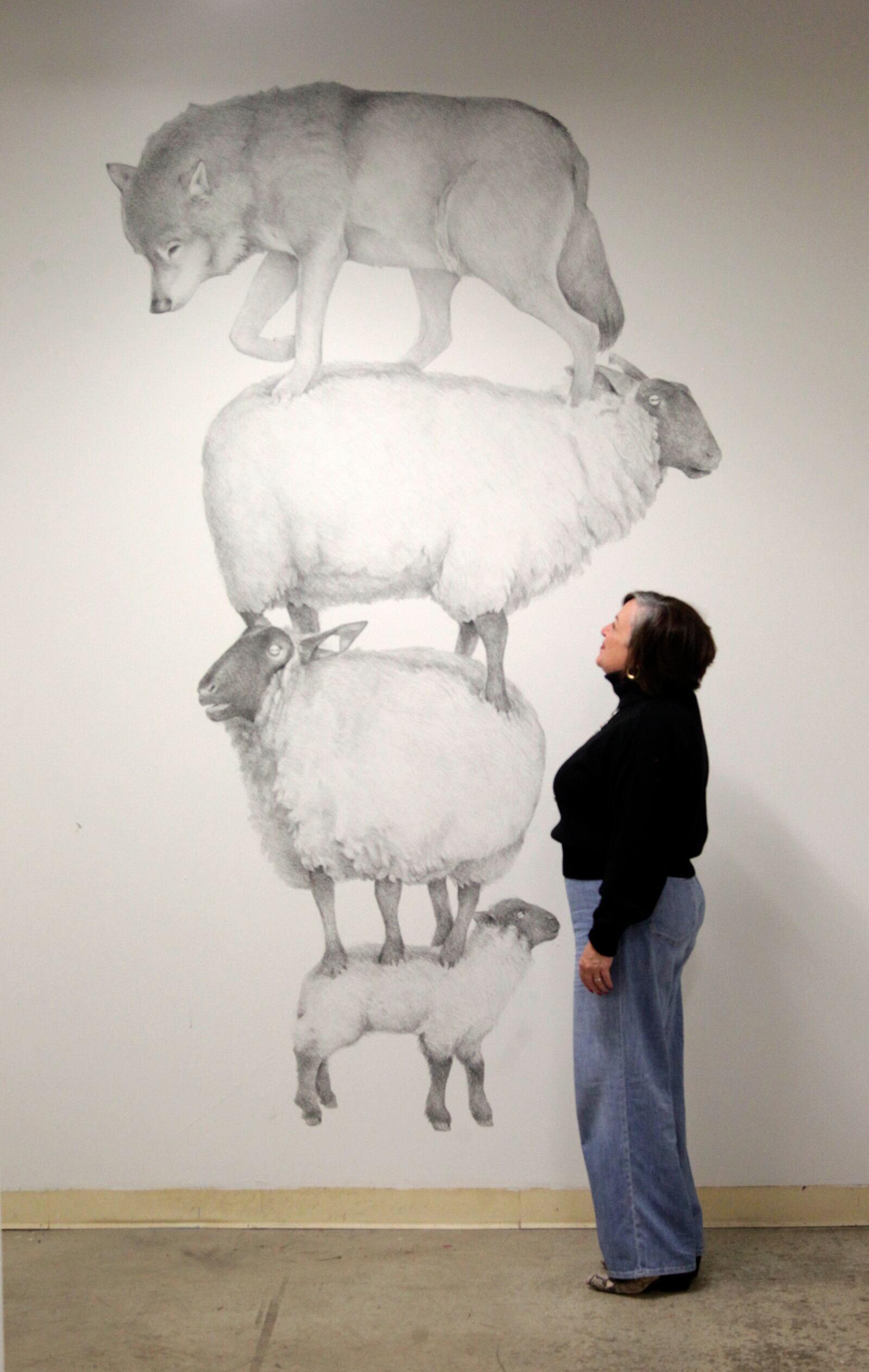 Large-scale drawings by artist Andrew Dailey, "Counting Sheep" and " Bloated Elevation" are on display in the Fountain Gallery, a secluded area at the back the The Contemporary Dayton. The art work will be on display until Dec. 21. LISA POWELL / STAFF