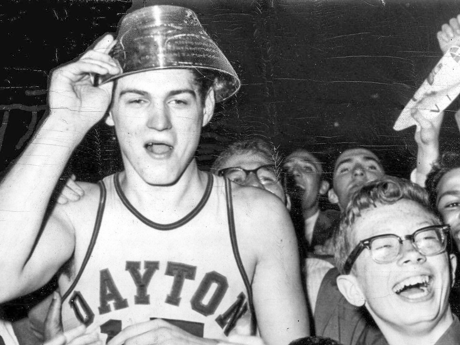 Bill Chmielewski, who led the University of Dayton to a 73-67 victory over St. John's in the finals of the National Invitation Basketball Tournament in 1962, is mobbed by delirious fans at the end of the game. On his head is the trophy he received as the most valuable player. UPI TELEPHOTO 1962 Dayton NIT.jpg